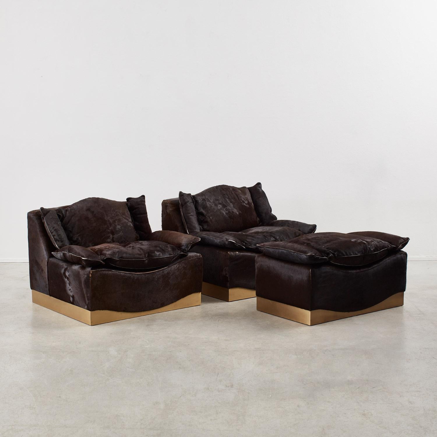 Blanketed in smooth brown-black ‘ponyhair’, these plump armchairs and ottoman by Luciano Frigerio speak to the Italian designer’s penchant for opulent materials; over the course of his nearly four-decade career, he also crafted pieces from brass,