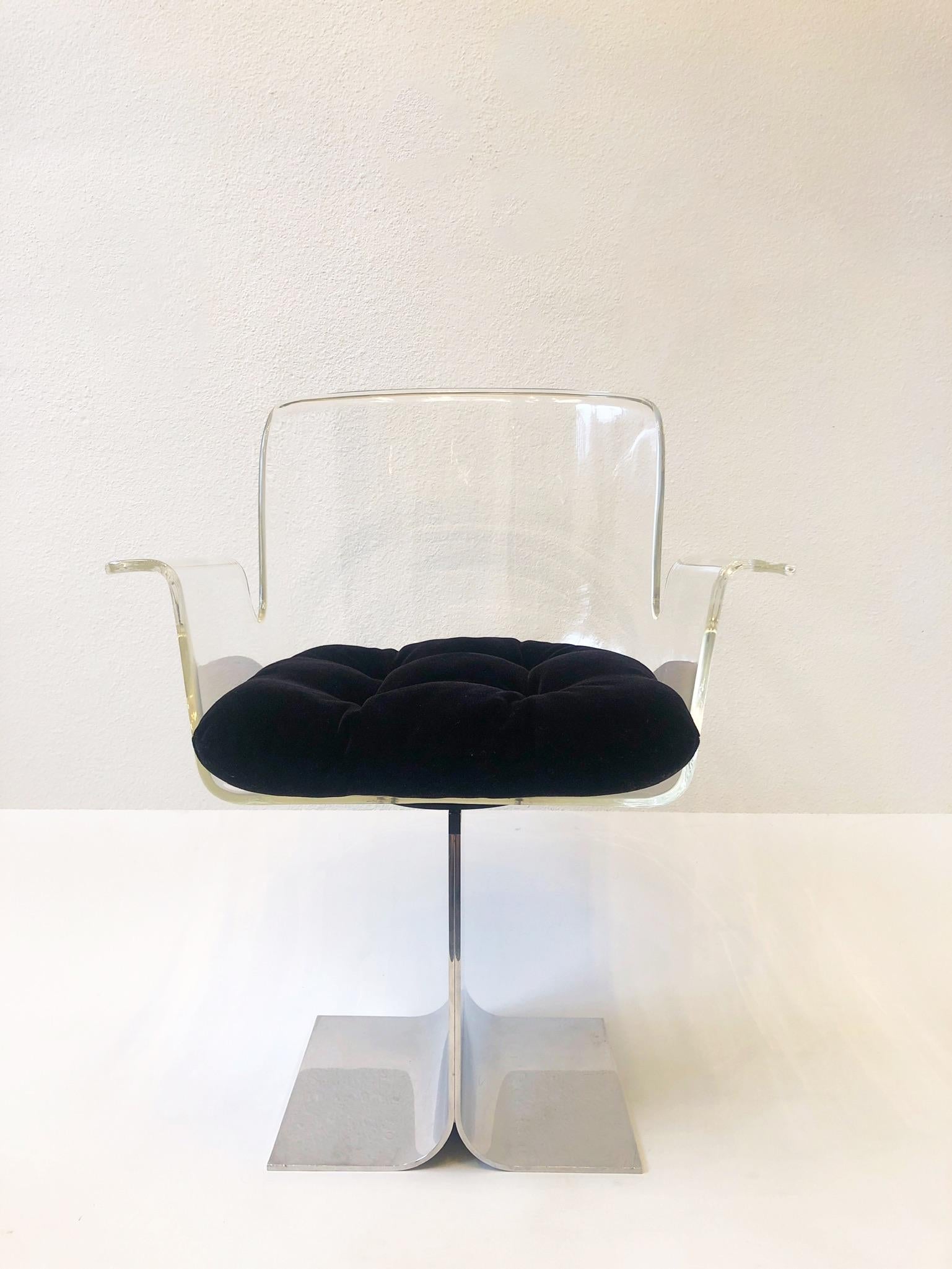 Pair of 1970 clear lucite and polished aluminum 180 swivel chairs by Pace collection.
The seat cushions are black mohair. 
The aluminum bases have been newly professionally polished. One of the chairs show slight crazing (see detail