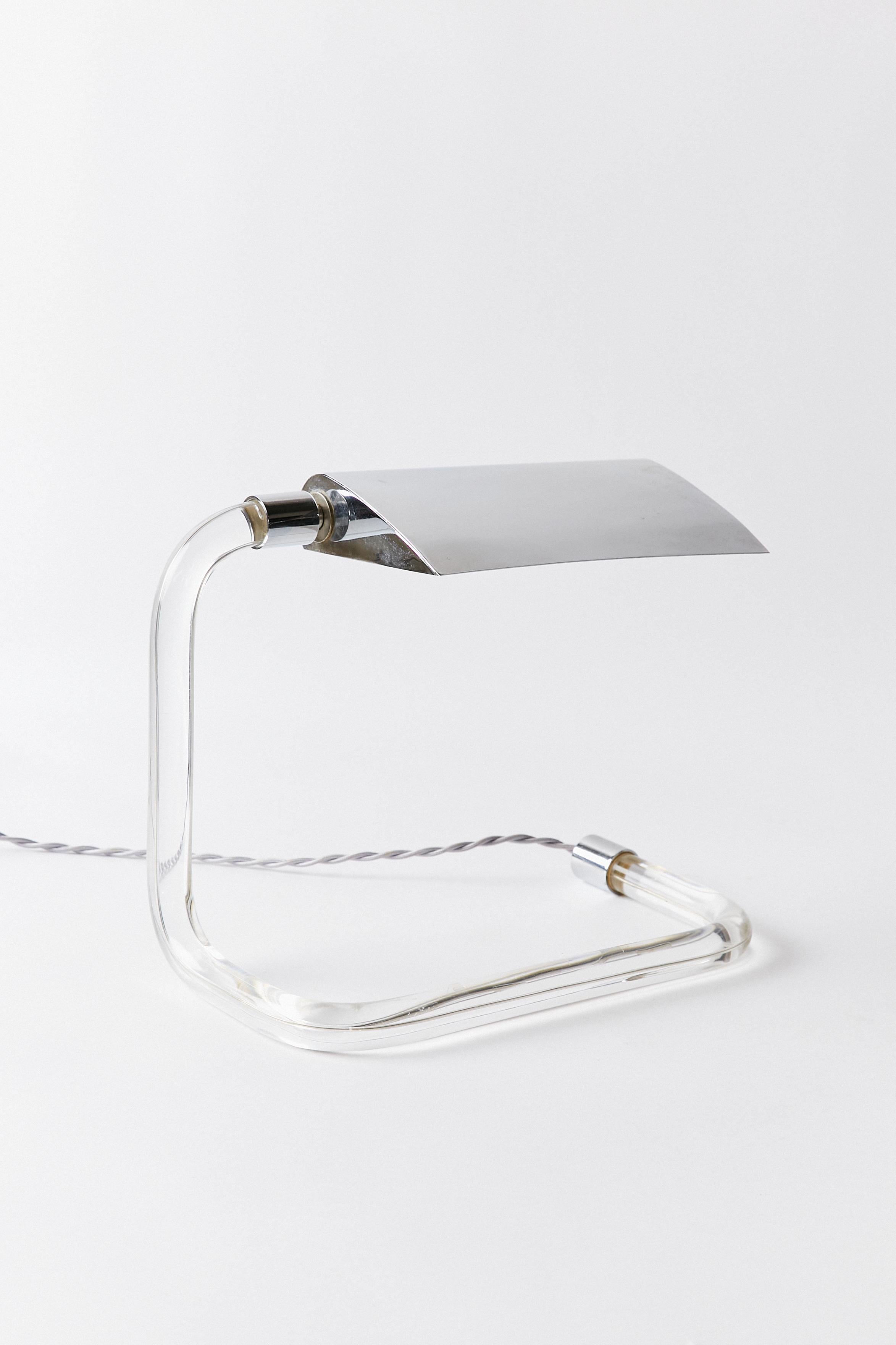 Set of two lucite and chrome desk lamps by Peter Hamburger, designed for Kovacs Lighting. This item has been rewired with braided cloth cord and new hardware.