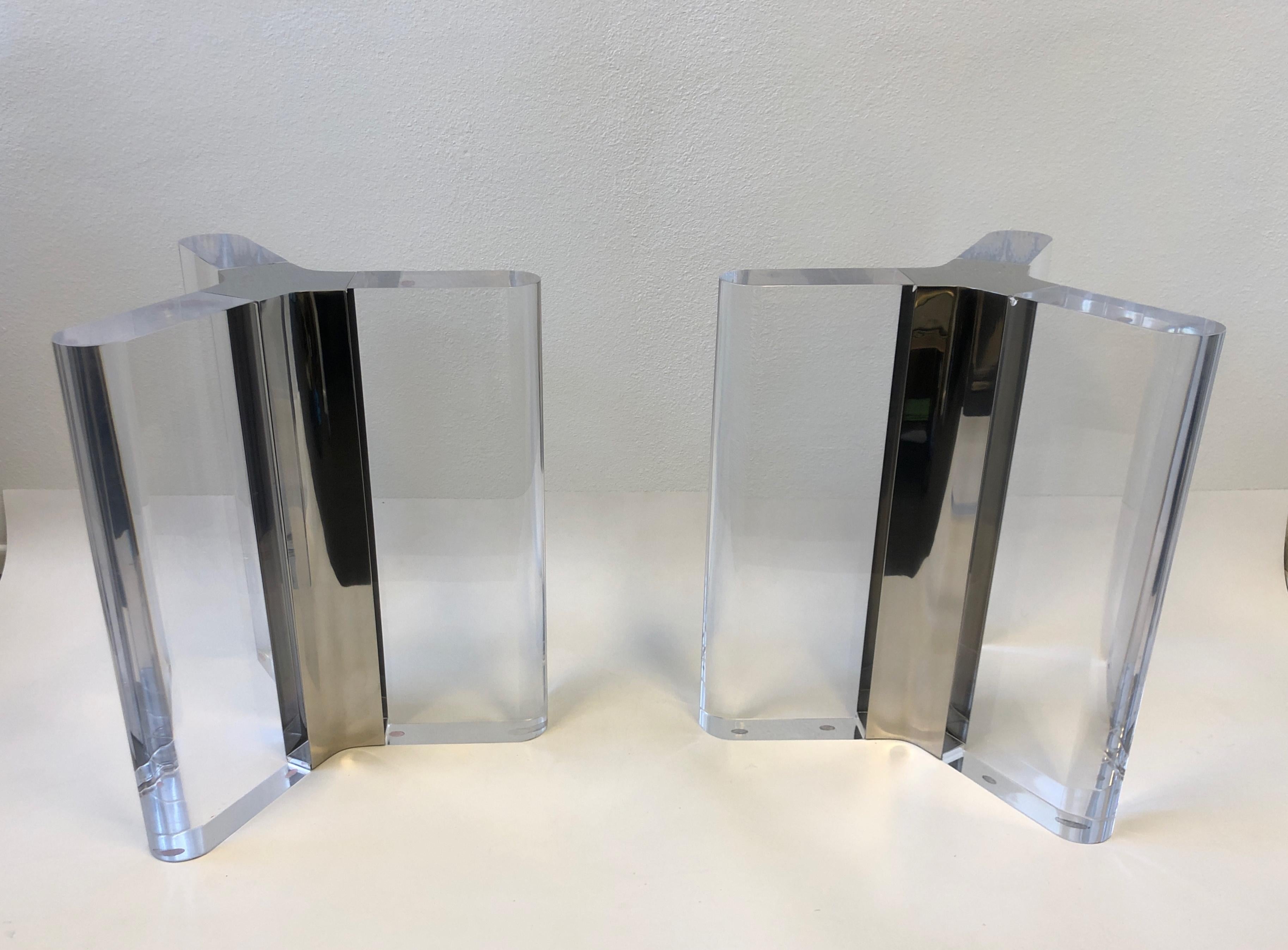 Pair of rare custom made clear lucite and polish stainless steel dining table bases. Design by renowned American designer Charles Hollis Jone (Mr Lucite). Newly professionally polished. The lucite is 4” thick, One of the bases has some inclusions