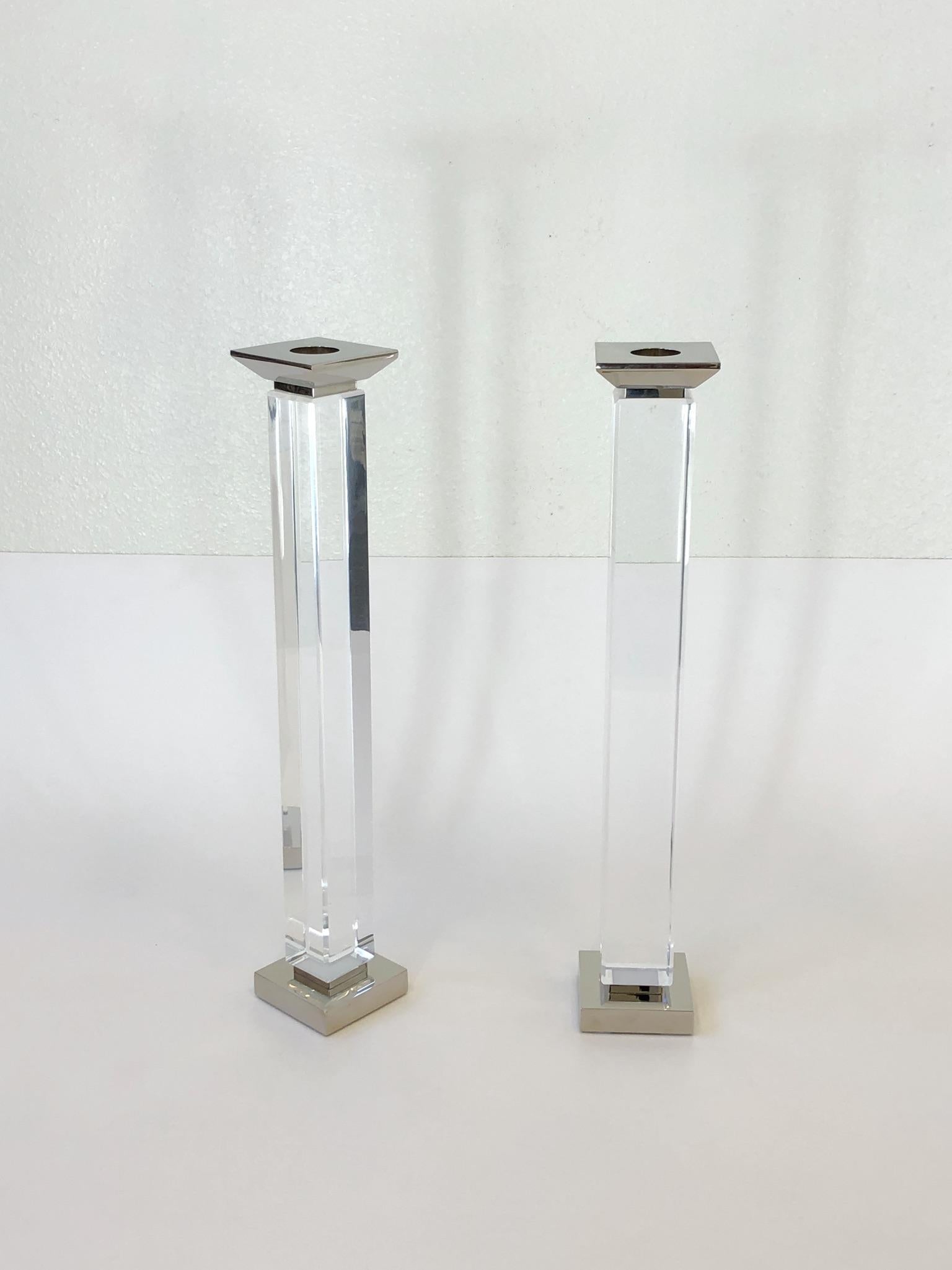 A glamorous pair of clear lucite and polish chrome candlestick by renowned American designer Charles Hollis Jones. 
Dim: 18.75 high 3.25” wide 3.25” deep.
