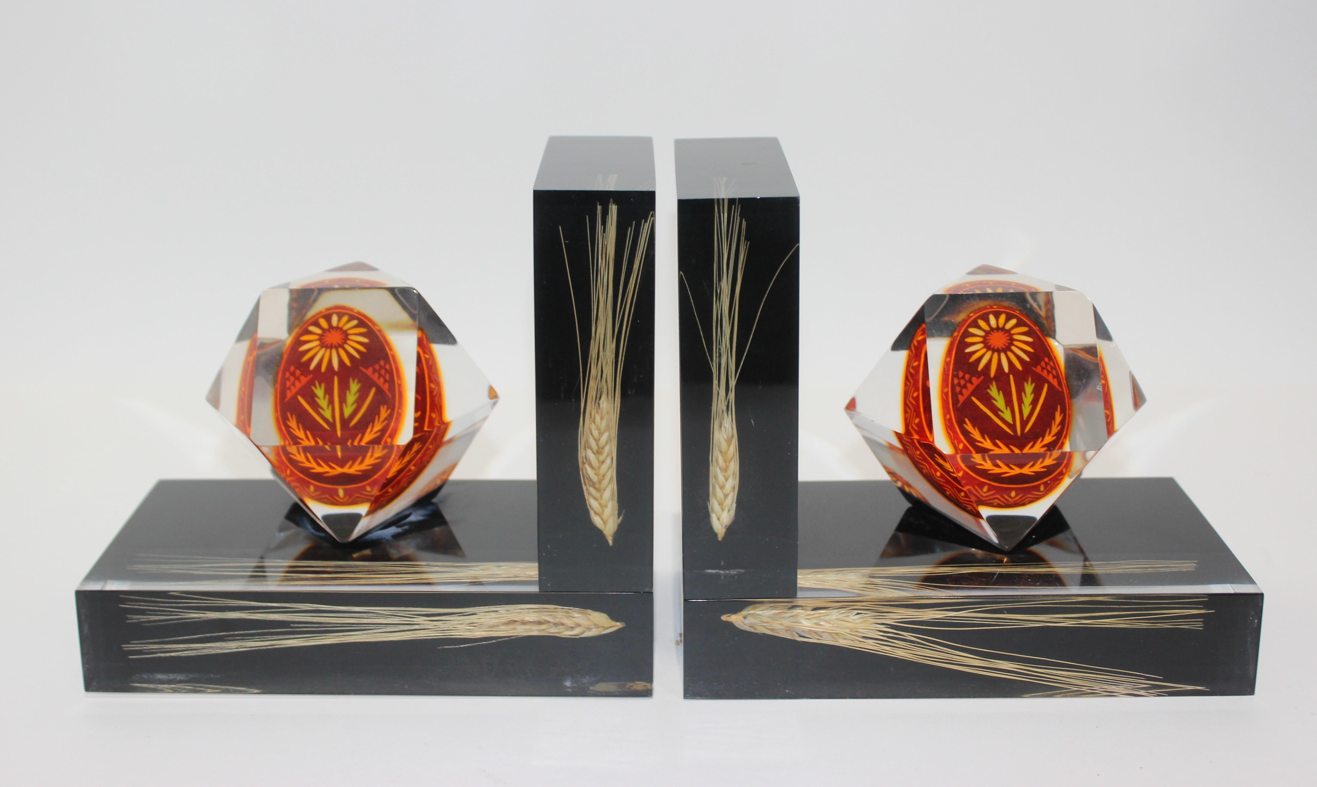 Bookends Lucite Encased Ukraine Pysanka hand painted Easter egg and sprays of wheat, a pair. Traditional folk are stylishly encased in faceted Lucite 