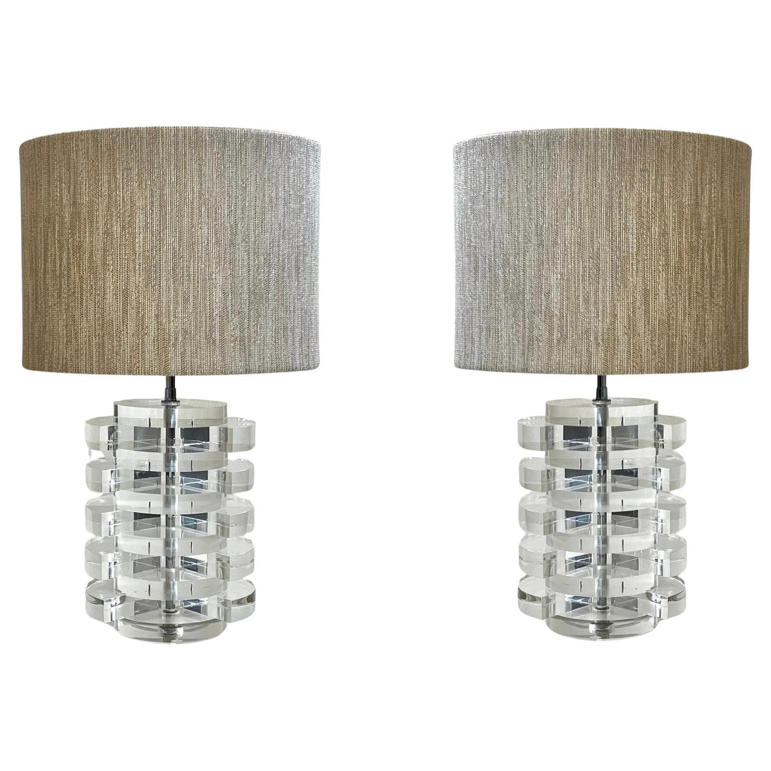 Glamorous pair of clear lucite and chrome table lamp by renowned designer Karl Springer. 
Newly rewired and new shades. 
Wired for US and take two 75w Max regular editions light bulbs. 

Overall measurements with shades 15” Diameter 24.75” High. 
