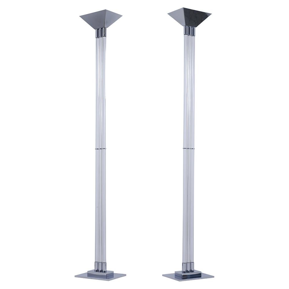 A beautiful 1960s Mid-Century Modern pair of Lucite floor lamps handcrafted out of steel and lucite. These floor lamps feature a beautiful Lucite column a chrome shade and base. These Vintage Lamps are wired to US standards, are in working