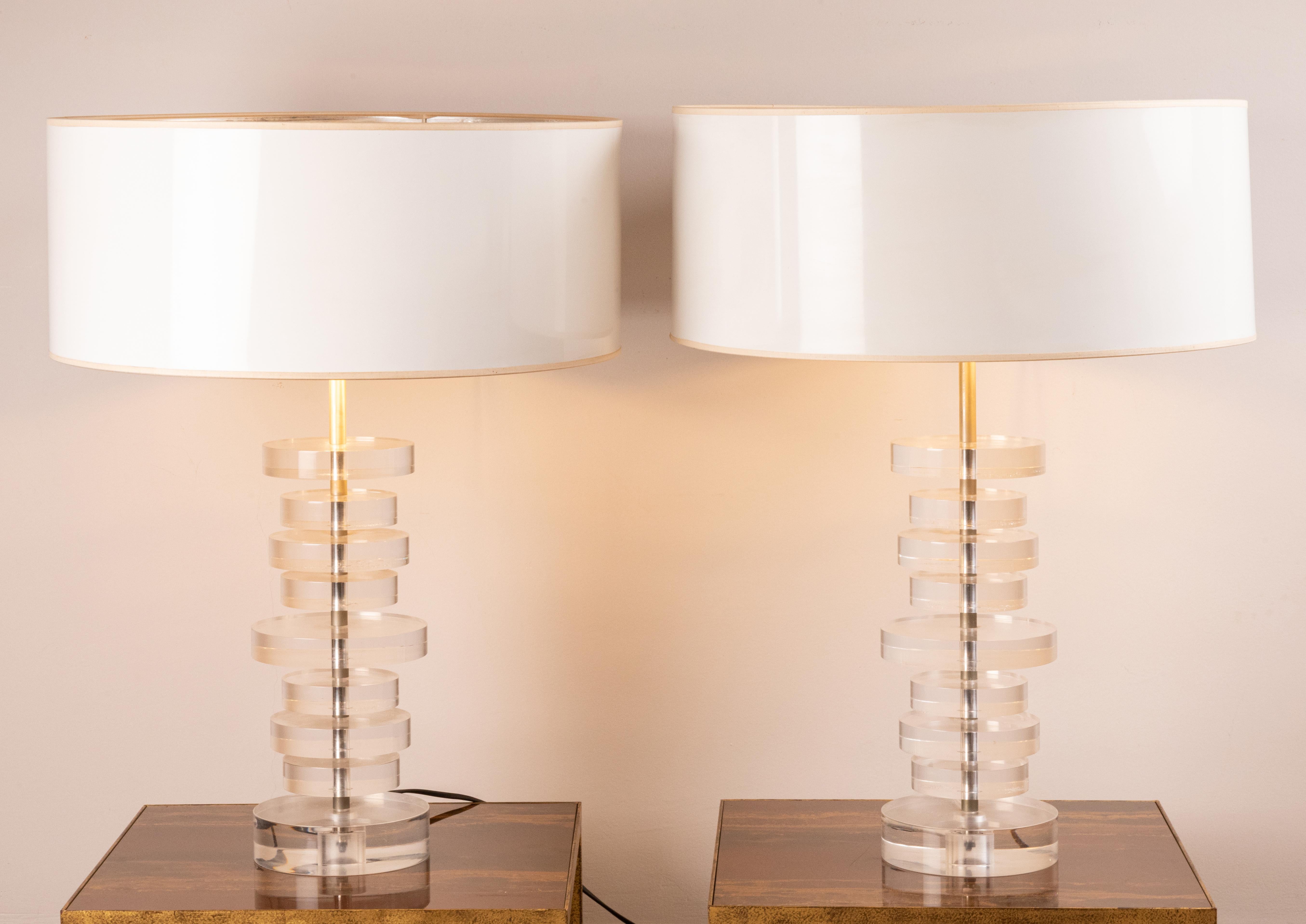 Pair of table lamps,
 Lucite cylinder discs on metal stem.
original shades in excellent vintage condition measures: H total: 64 cm (25.2 inches) 
H plexi lamp: 36 cm (14.2 inches) 
Diameter shade: 48 cm (18.9 inches)
Diameter lamp: 15 cm (5.9