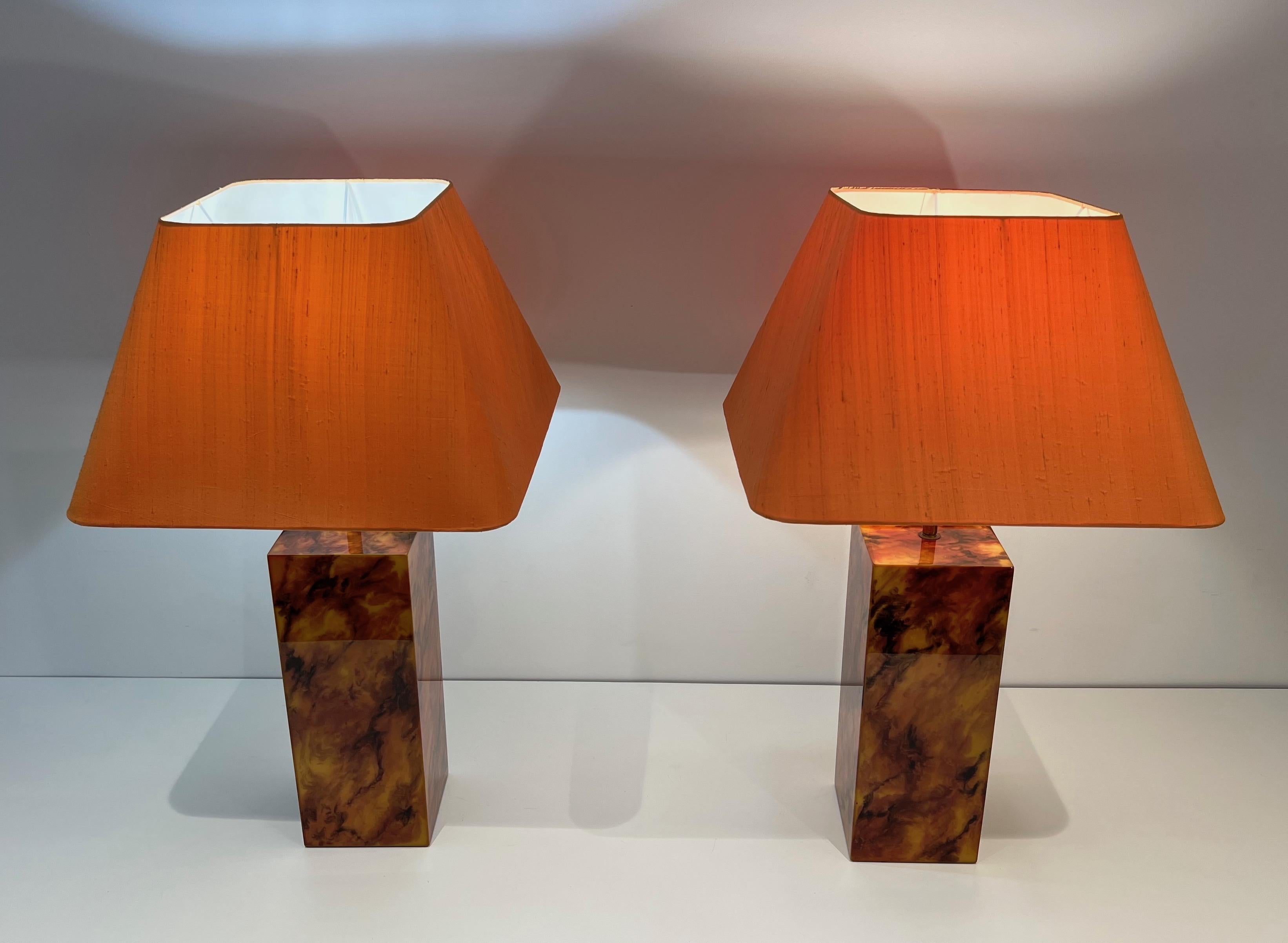 This beautiful pair of table lamps are made of lucite. These lamps are  imitating Tortoise Shell. This is a French work. Circa 1970