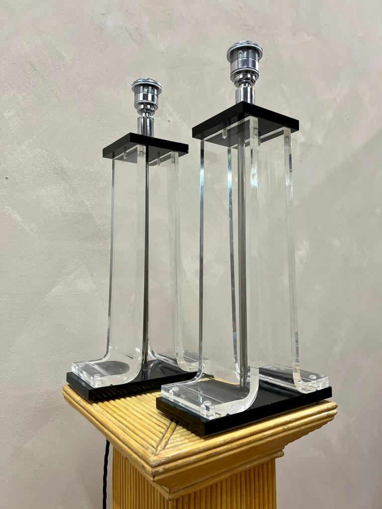 Stylish pair of lucite clear and black table lamps 
Pat tested and re wired these are ready to go into the home or shop.
In the manner of the American artist and furniture designer Charles Hollis Jones , who made lucite his signiture Material
