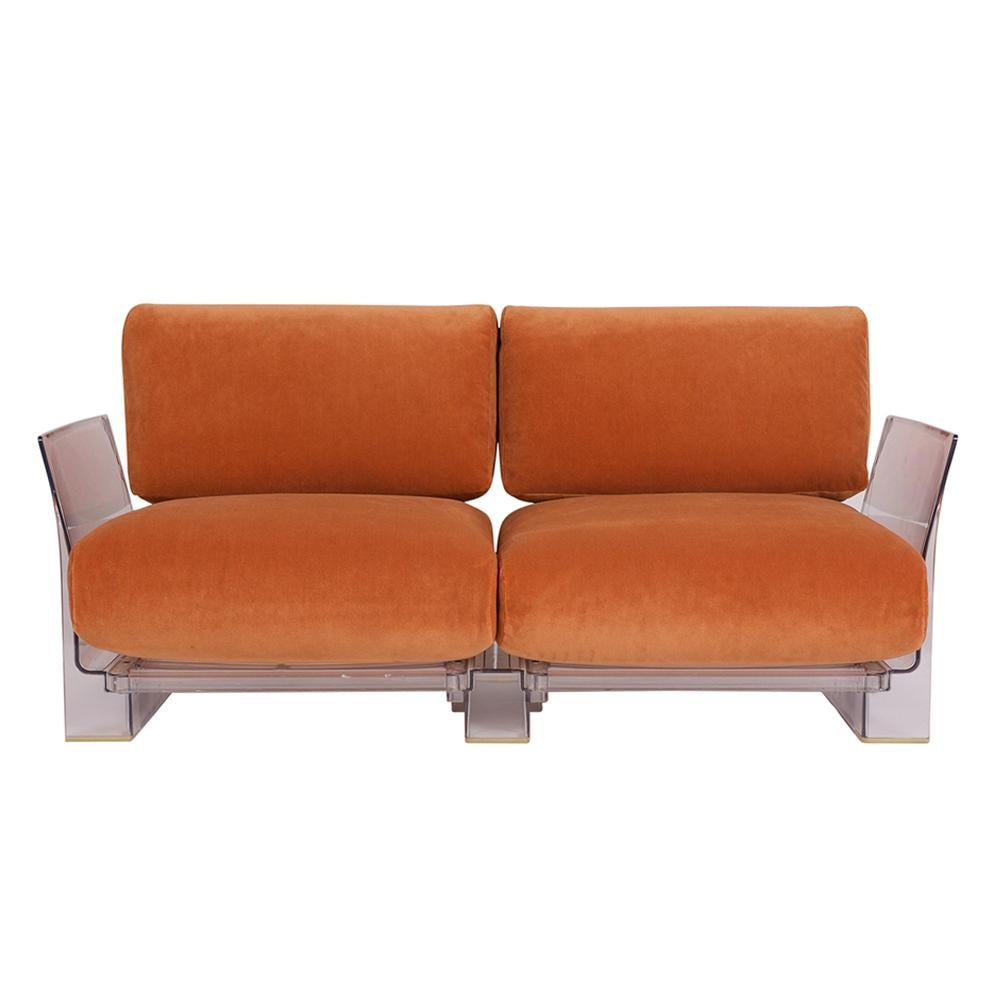 This pair of Lucite loveseats or sofas are designed by Piero Lissoni for Kartell. Each sofa features a stylish Lucite frame in great condition with 2 seat and back cushions. The cushions have been professionally reupholstered in an orange mohair
