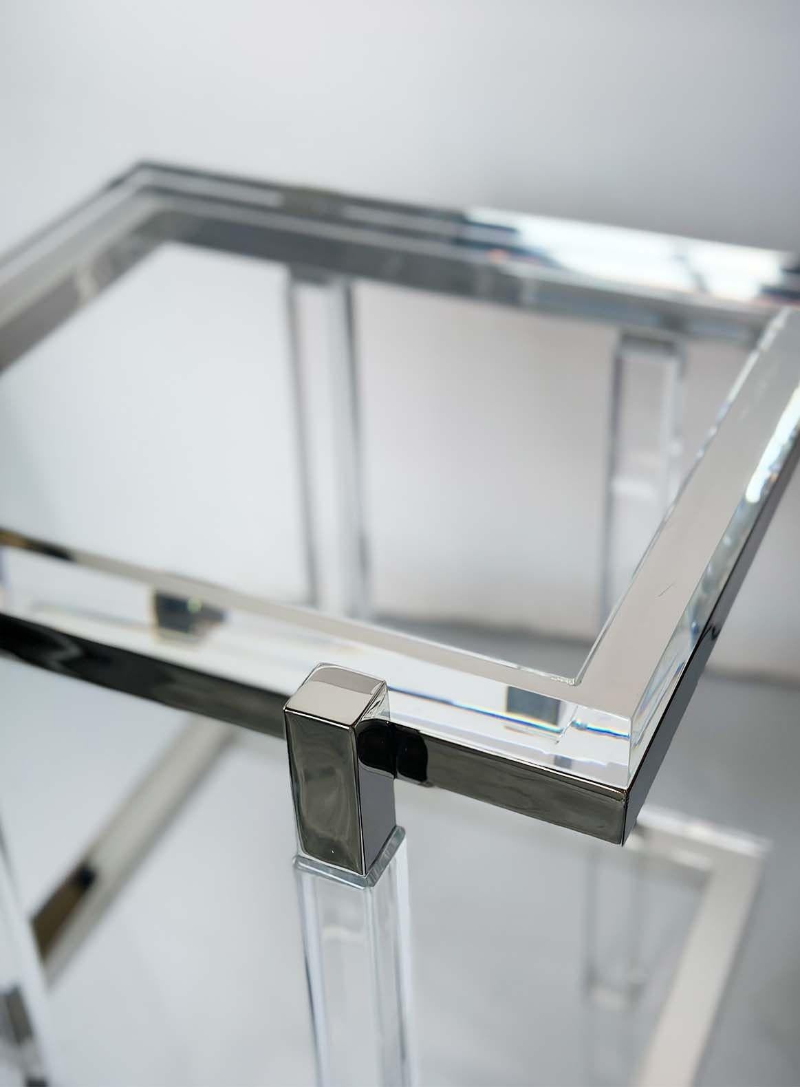 Pair of modern end/side tables made of thick lucite shelves and nickel supports.
Made in USA, 21st Century.
Signed 