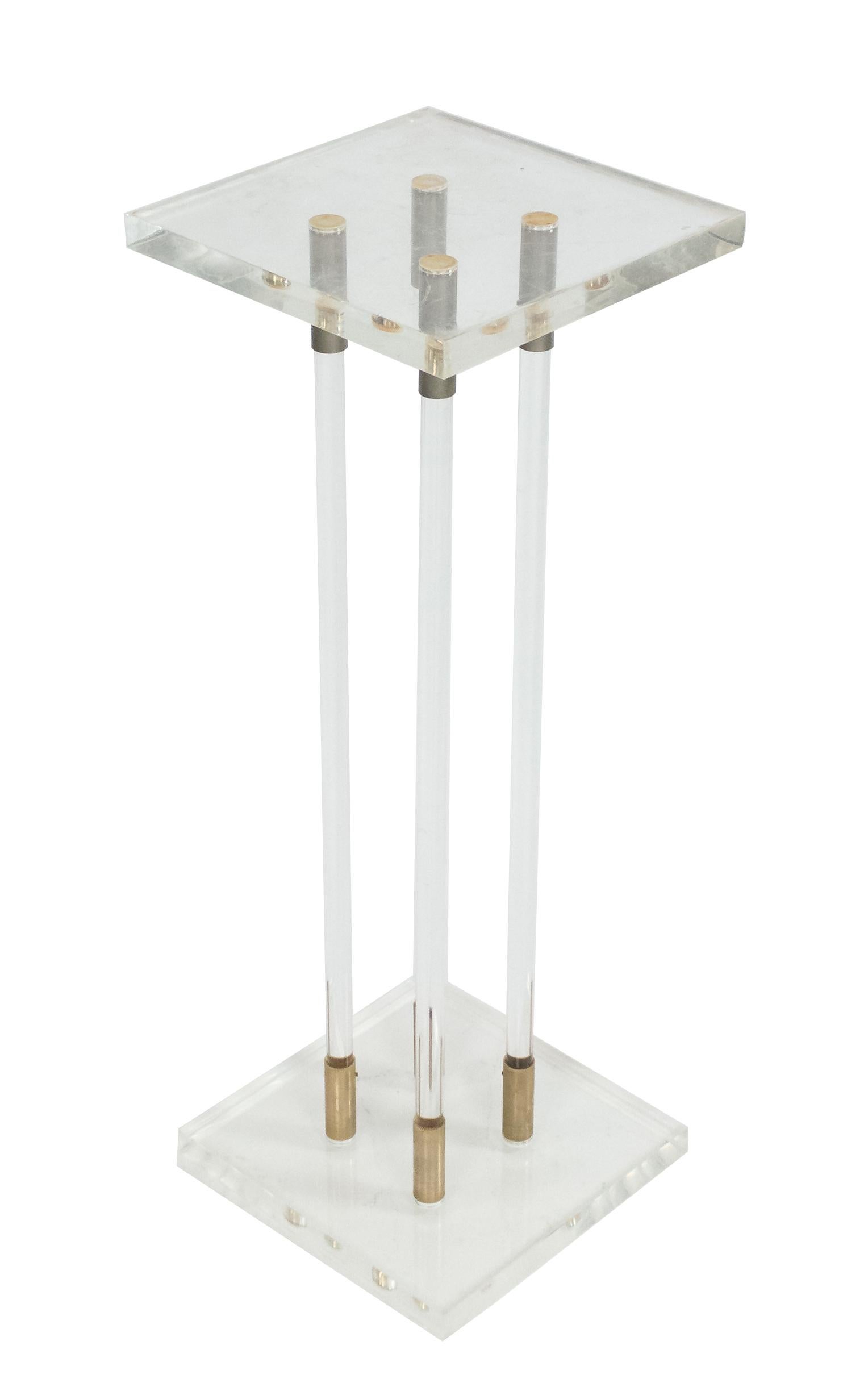 Pair of contemporary Lucite pedestals with four Lucite supports, gilt metal details, and square bases and tops.