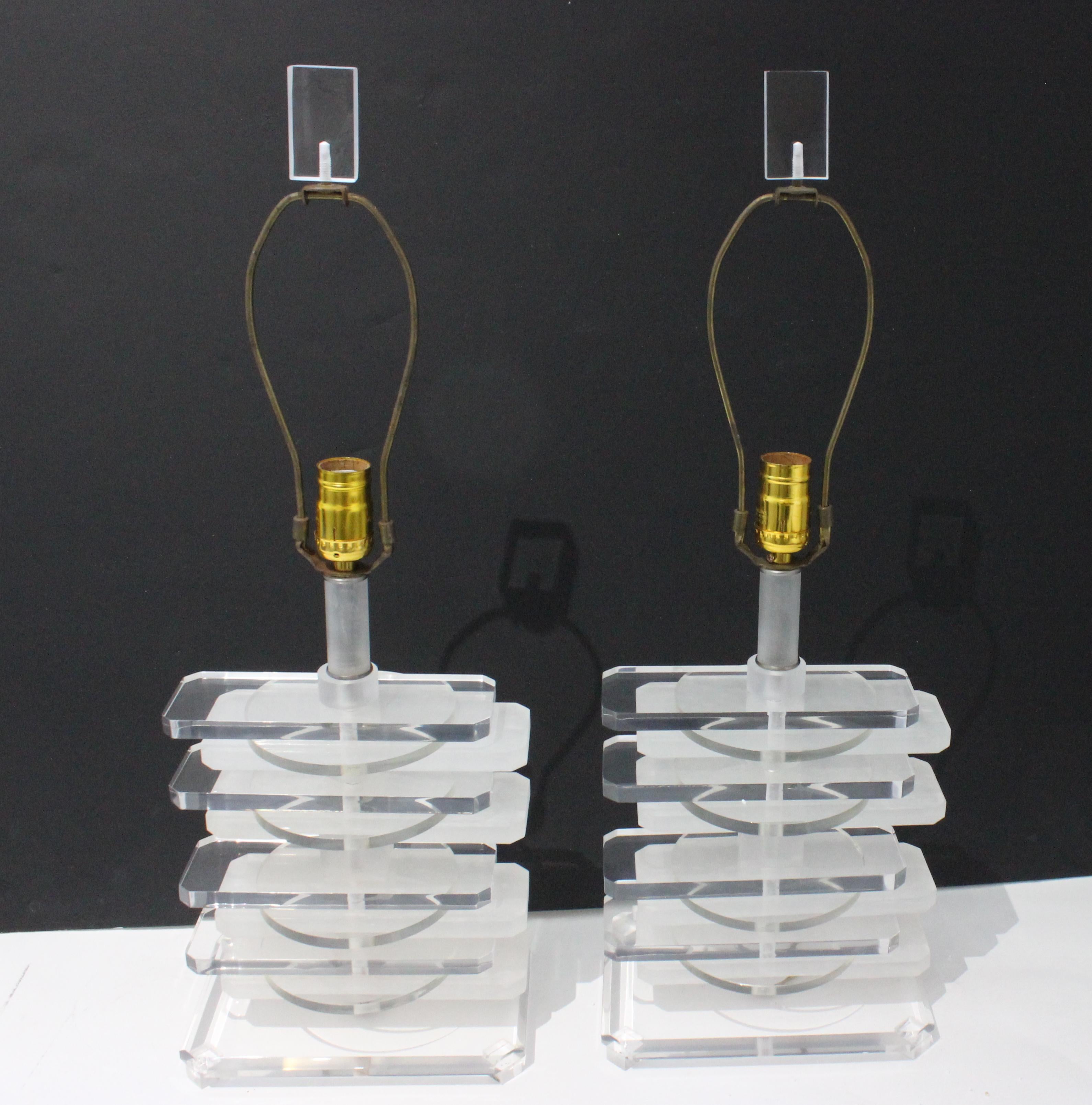 This stylish and chic pair of 1980s lucite lamps will make a statement with the stacked-form, and use of translucent and frosted pieces.

Note: The lucite has been professionaly polished and have been rewired.