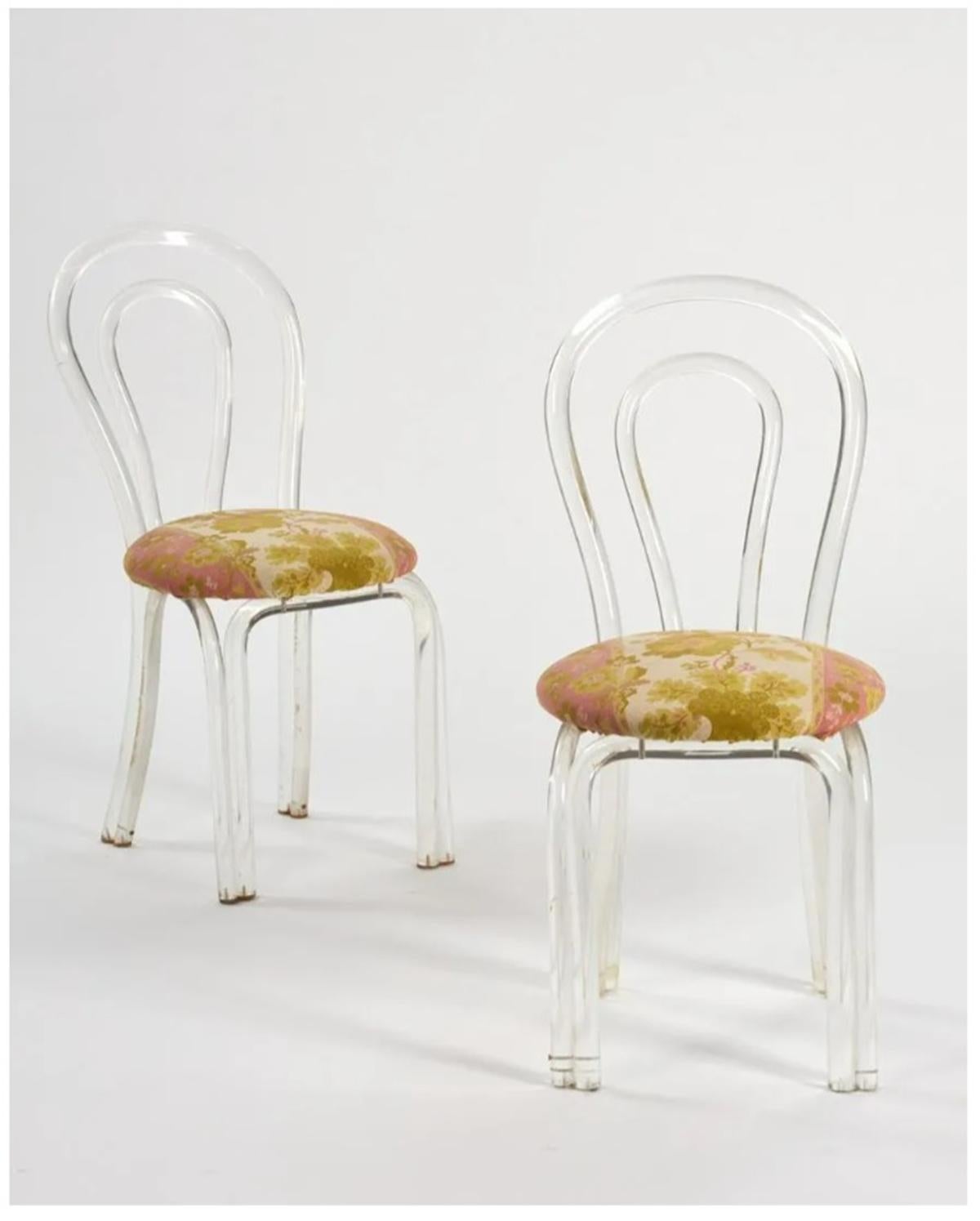 Beautiful pair of Lucite side or vanity chairs attributed to Dorothy Thorpe.
The chairs are made of solid Lucite rods bent to create a beautiful shape for the back and legs of these chairs.

The chairs retain the original fabric and the Lucite is