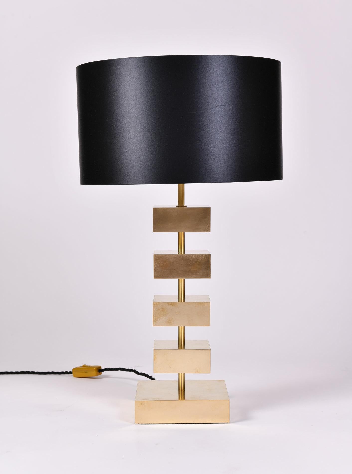 Bold 'Luigi' table lamps. Four impressive solid brass floating squares connected by slim brass columns. Larger brass square at the base. 

Also sold individually.

47cm high (lamp only) x 16cm² wide (base).

62cm high x 36cm diam. with shades.