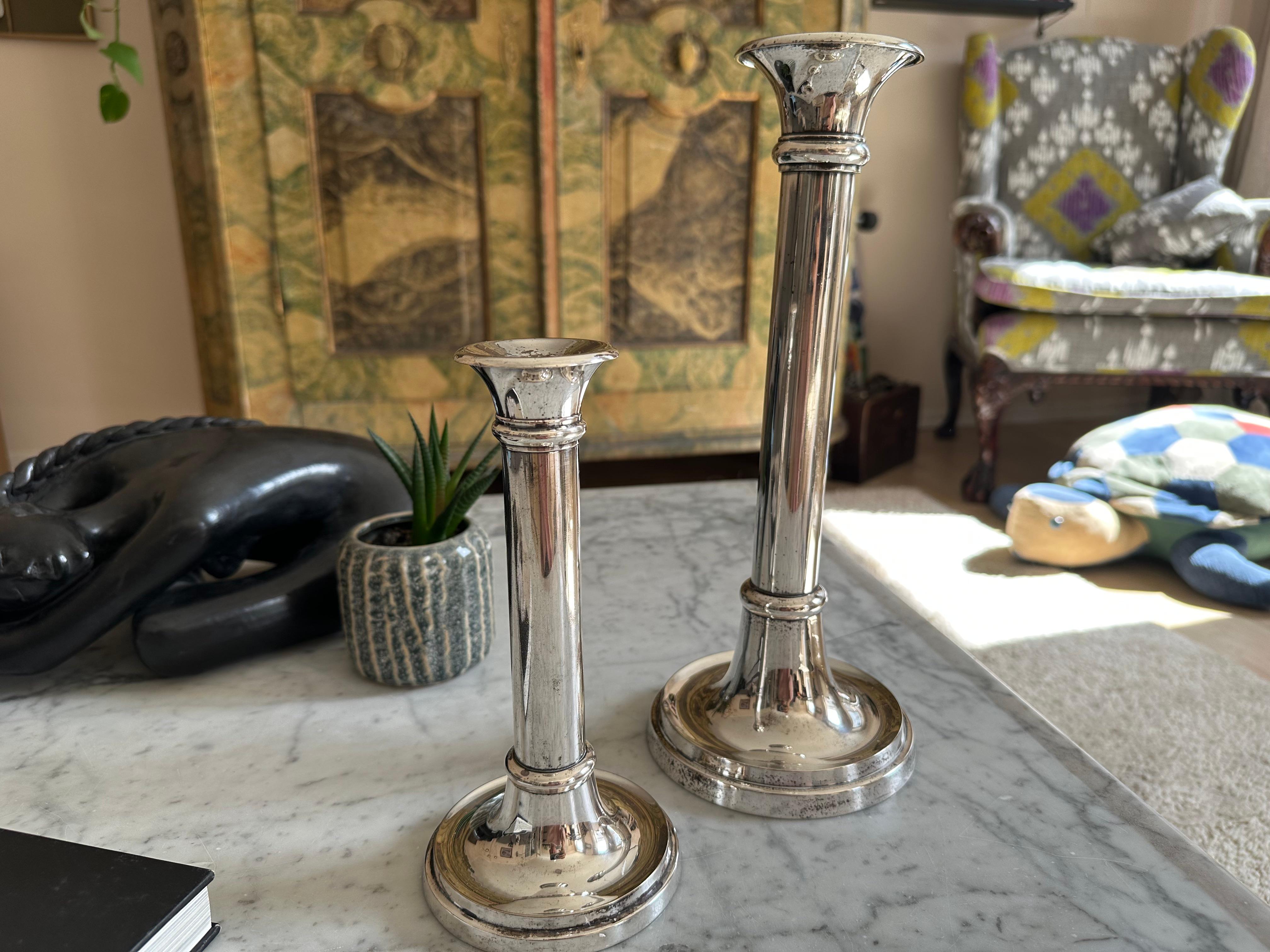 This striking pair of silver-plated candlesticks, model “Luise,” was produced by the esteemed German design house Lambert in the 1970s. Lambert is known for its high-quality craftsmanship and sophisticated home accessories that combine traditional
