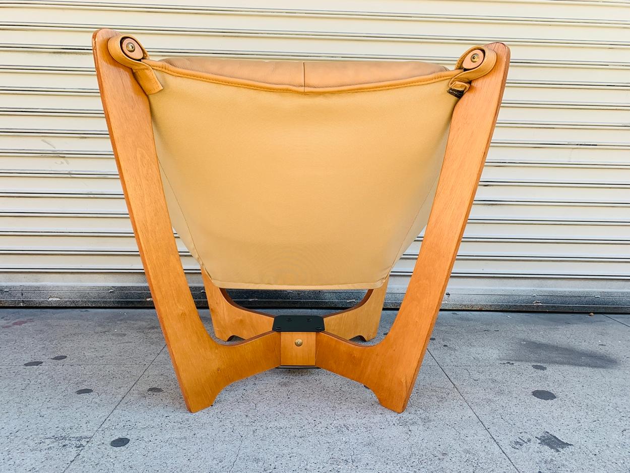 Offering a very nice pair of Luna chairs in tan leather and teaks frames by Odd Knutsen. The chairs are extremely comfortable, they sit on a four post teak frame with sturdy leather straps fastened to the frame. The leather is in good vintage