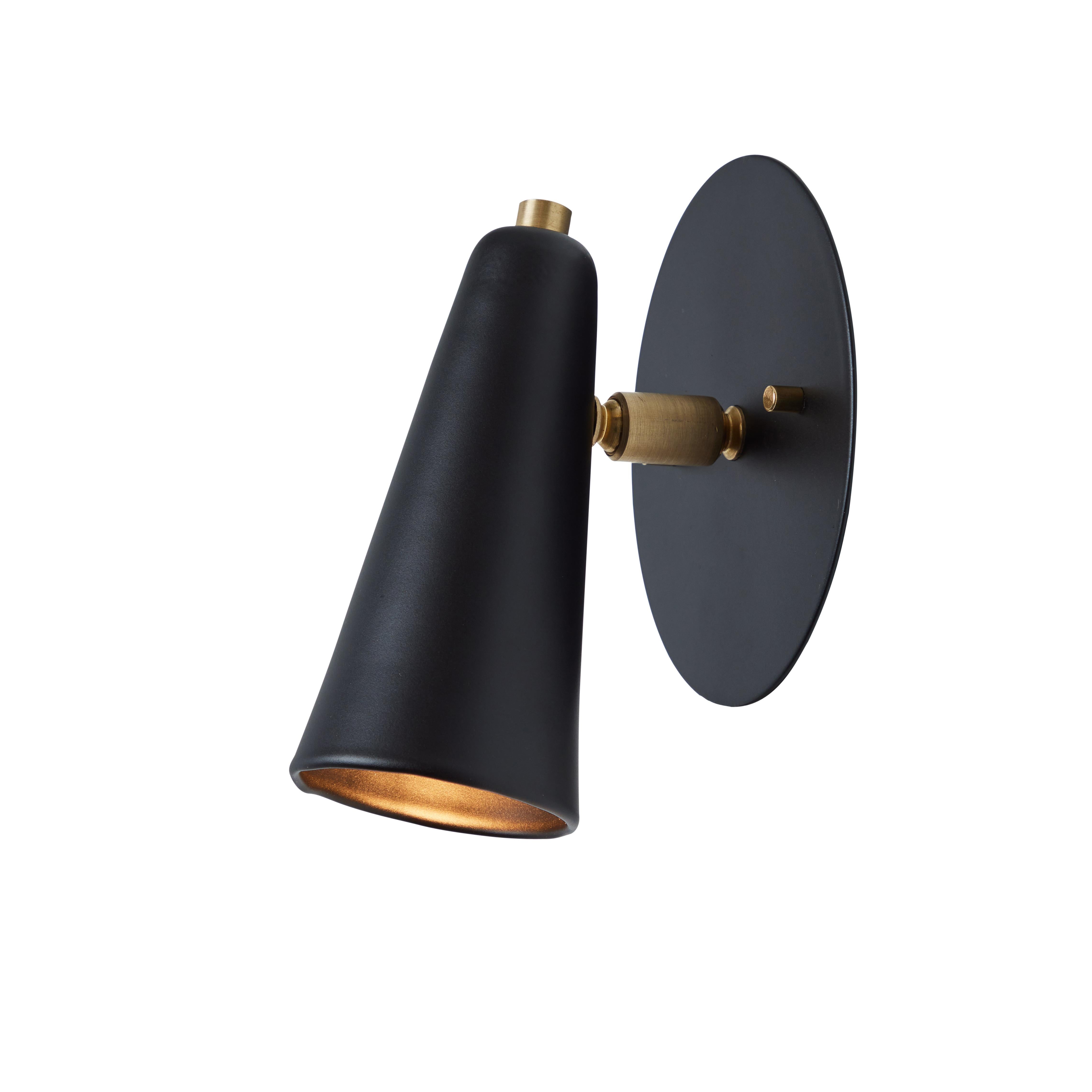 Pair of 'Lupita' sconces in black and brass by Alvaro Benitez. 

Hand-fabricated by Los Angeles based designer and lighting professional Alvaro Benitez, these highly refined and highly adjustable sconces are reminiscent of the iconic midcentury
