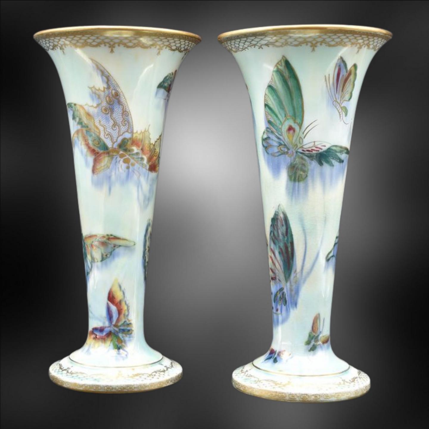 A pair of large trumpet vases, decorated with 'grotesque' butterflies on a mother-of-pearl lustre ground.

Probably the best of Wedgwood's female designers, Daisy was an eccentric character, who pushed her way into a world dominated by men, and