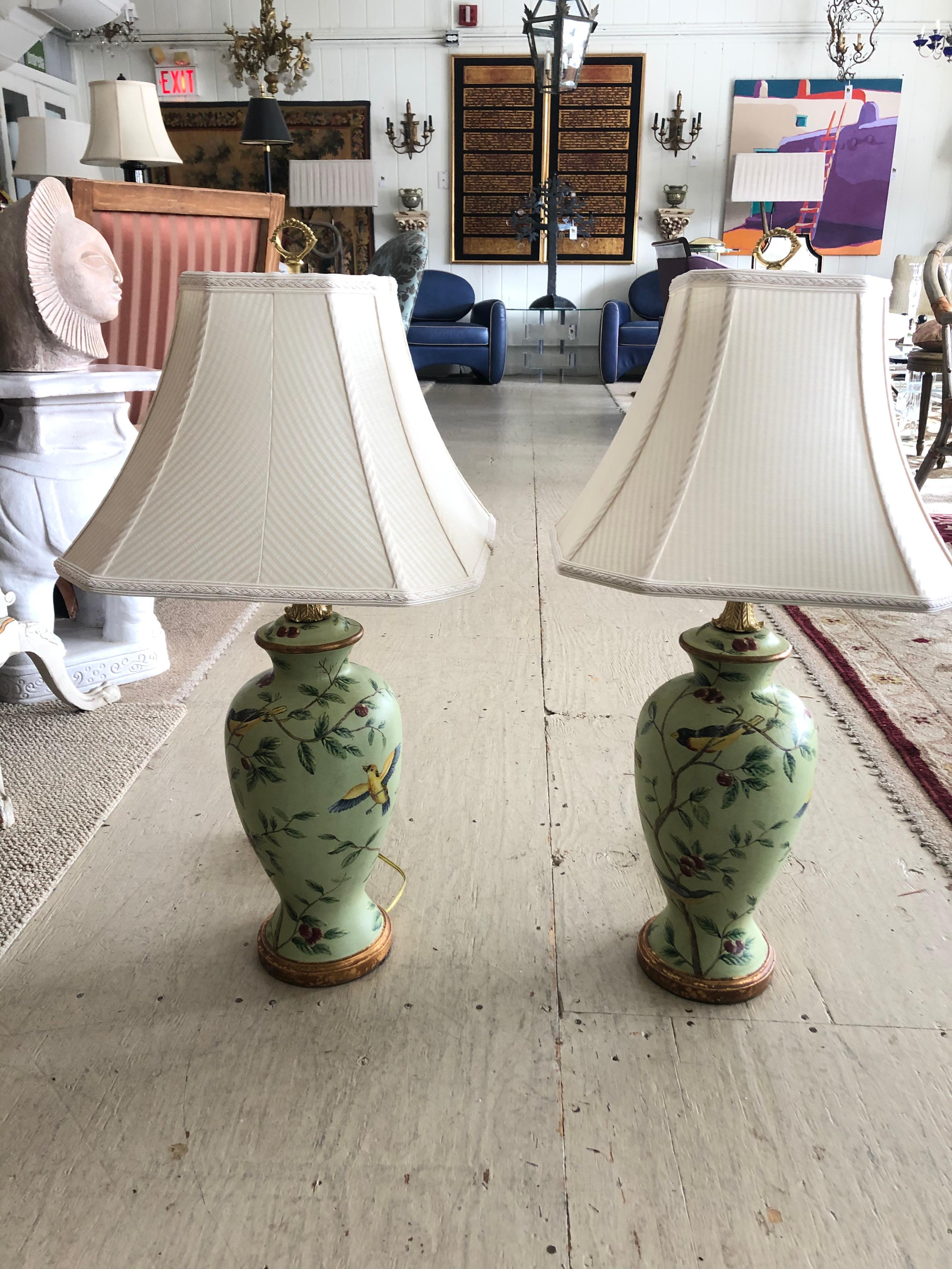 A beautiful pair of celadon green painted table lamps having birds and foliage, bronze gold details and very pretty finial. These Bradburn lamps retail for $900 each!
Lamp urns are 8