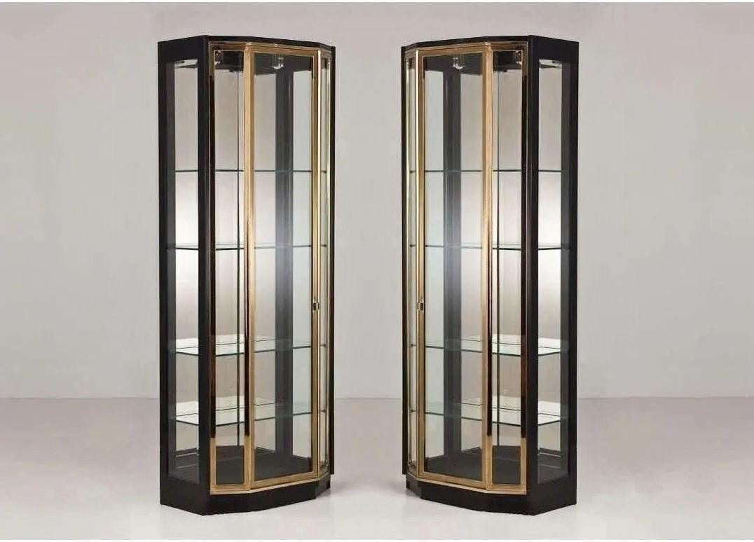 An exceptional pair of tall illuminated vitrines by Henredon, gracefully combines traditional forms with modern design elements. Good design, meticulous tailoring and superior construction have established the Henredon standard of quality for many