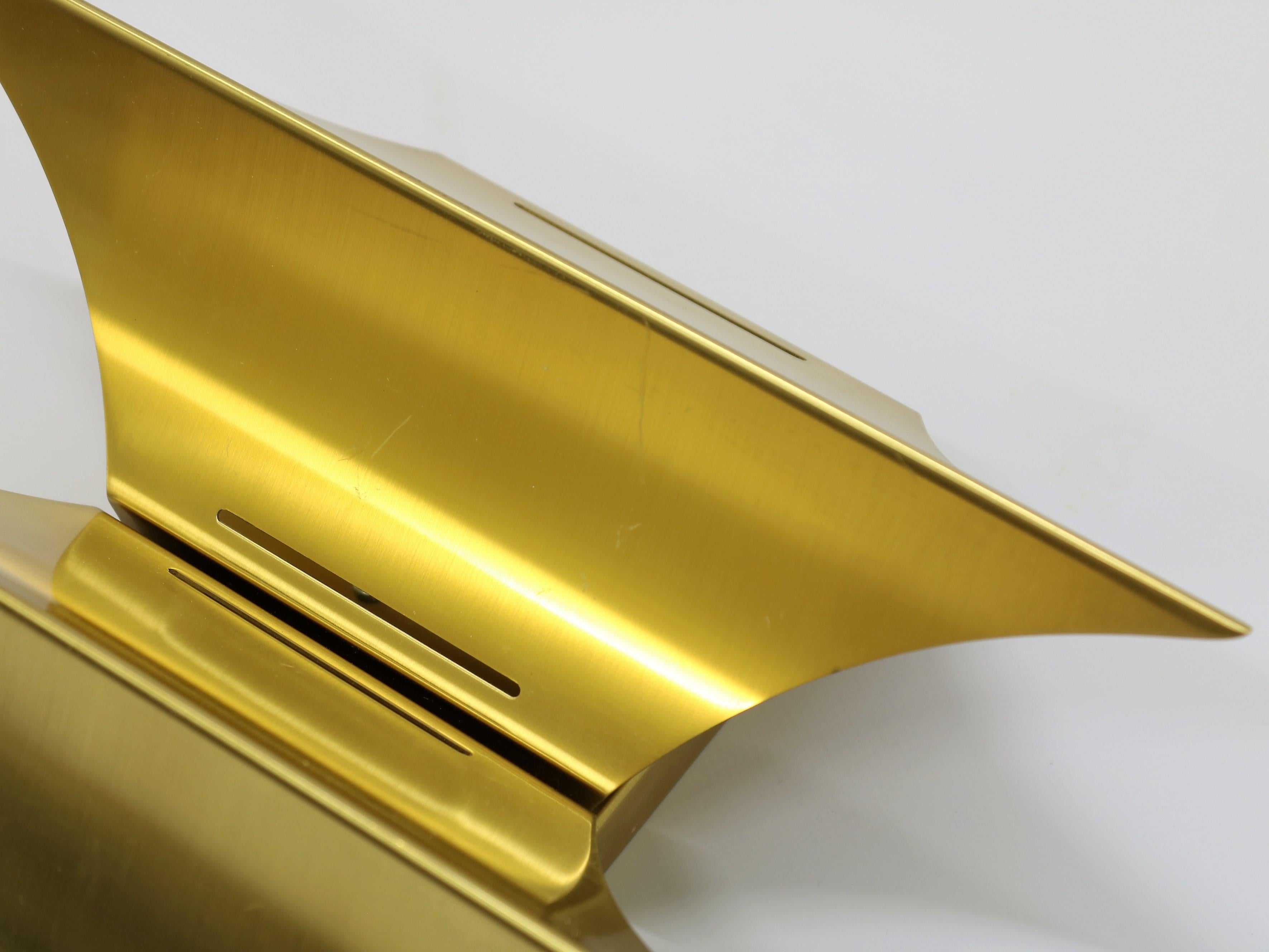 Made by Danish lighting manufacturers Lyfa in the mid-1960s this lamp is not only a source of light but also a sculptural decoration on the wall. The lamps are made from solid brushed brass in high quality. Strangely enough the designer of this