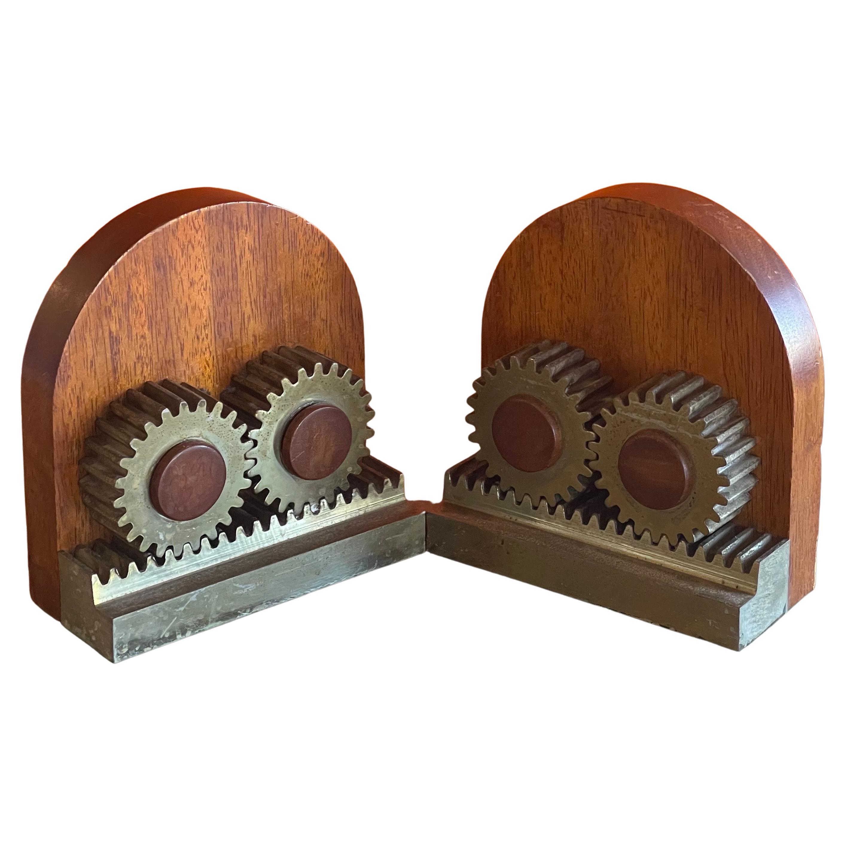 Unique pair of machine gge Art Deco gear bookends, circa 1940s. The bookends are made of a solid hard wood with aluminum and brass 