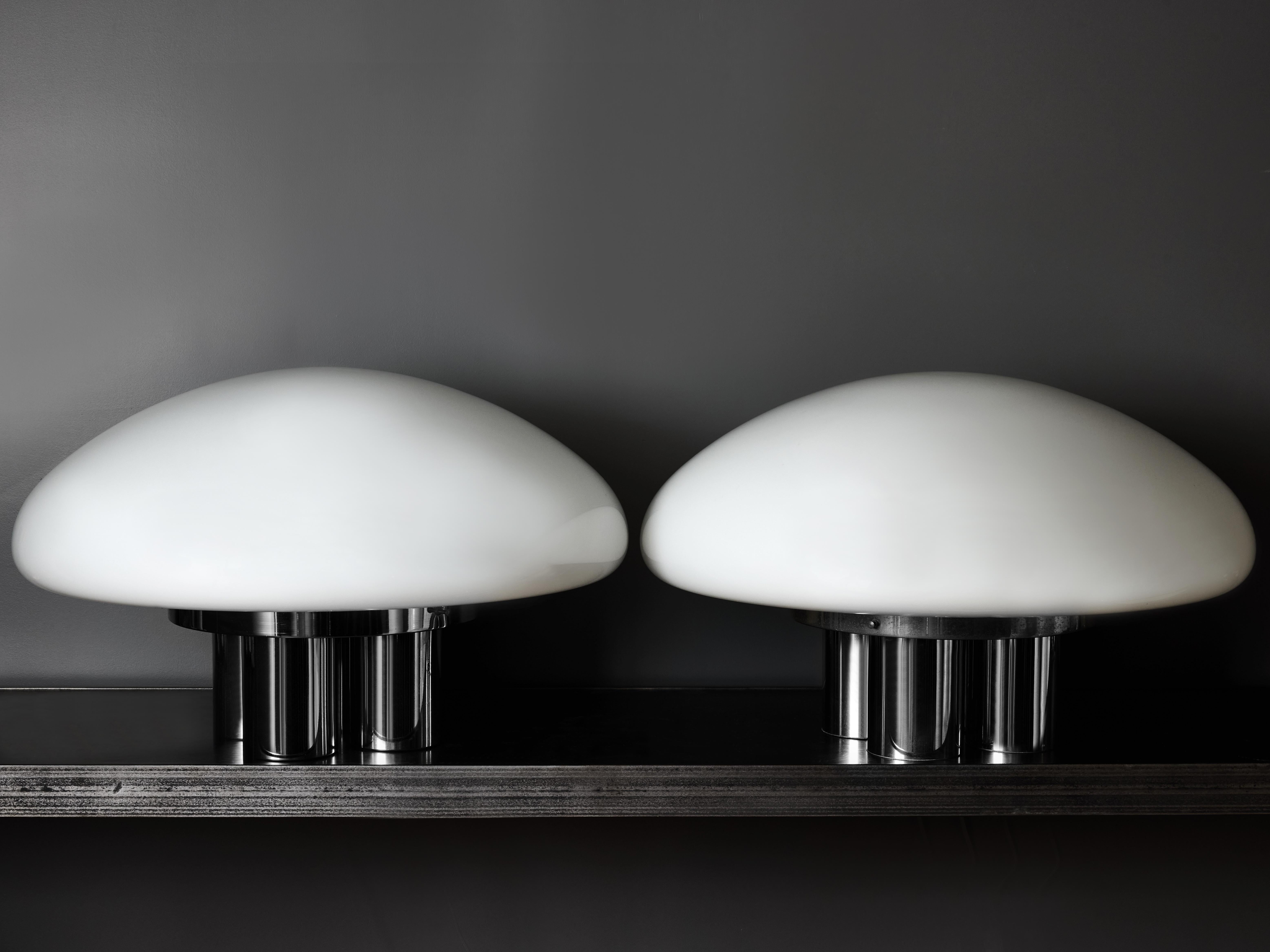 These rare examples, especially as a pair, are the large version of the Magnolia designed by Sergio Mazza and Giuliana Gramigna for quattrifolio Design circa 1973.
Made of a chromed metal base and a large white glass light diffuser.

SERGIO