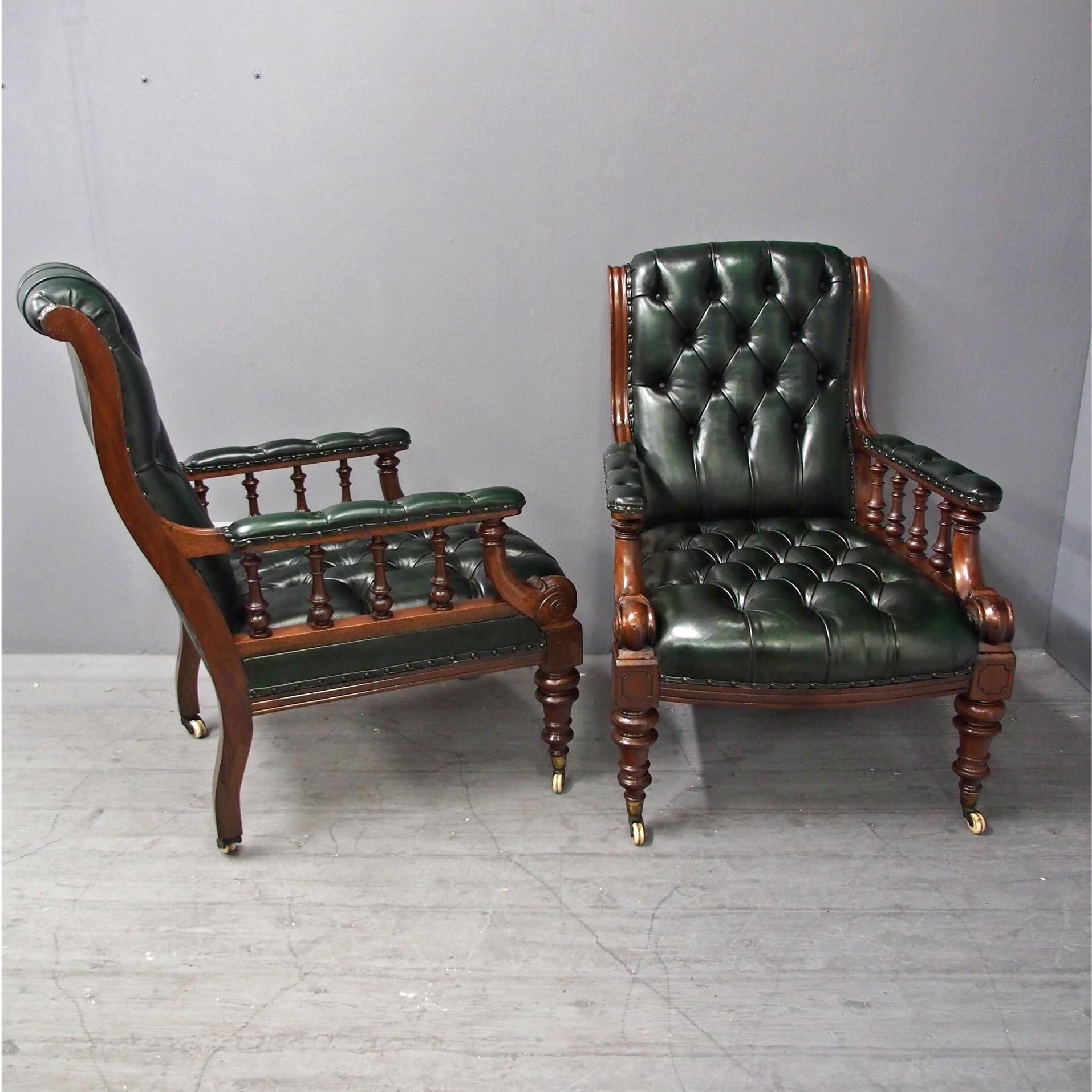 Pair of mahogany and leather library chairs, circa 1870. Recently re-upholstered in hand dyed green leather with deep buttoning, with a rounded top and padded back flanked by uprights. These continue down to the deep button arm rests which are held