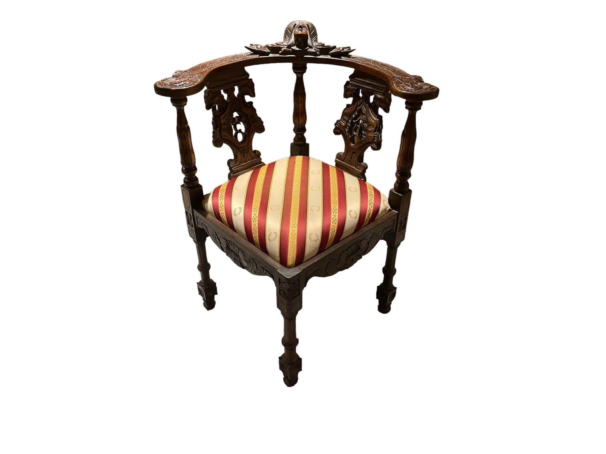 This pair of mahogany carved Victorian-style corner chairs is a true testament to the elegance and grandeur of the Victorian era. Crafted with meticulous attention to detail, these chairs exude opulence and sophistication. Made from rich mahogany