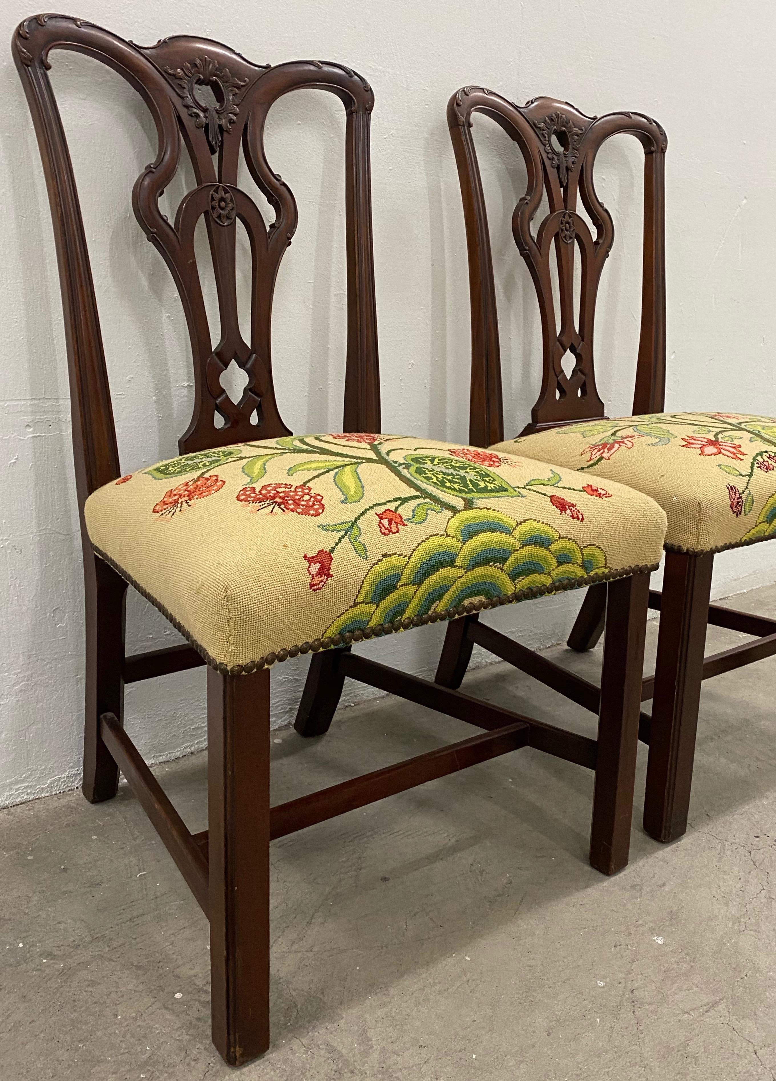 Pair of antique mahogany Chippendale style side chairs with needlepoint seats 19th century.

Beautifully carved mahogany side chairs. Each seat has a unique Art Deco floral design.

Dimensions 22