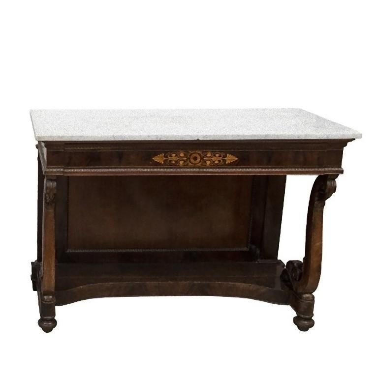 This pair of mahogany console tables is a furniture piece realized in Piedmont, Italy during the first years of the 19th century.

These console tables are made of mahogany with boxwood inlays and carved legs with fan end. 

Dimensions: cm 130 x