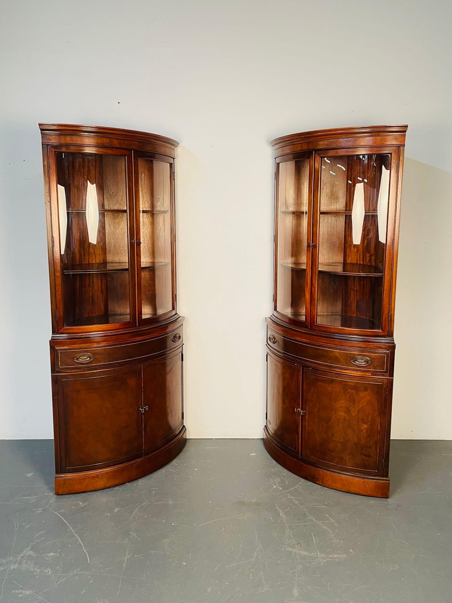 Pair of Mahogany Demi Lune Corner Cabinets, Bookcases / Vitrines, Circa 1940

Each having a deep bowed front with double bowed glass doors over a single drawer and two doors leading to a fitted shelved interior. Each in a nice fine flame