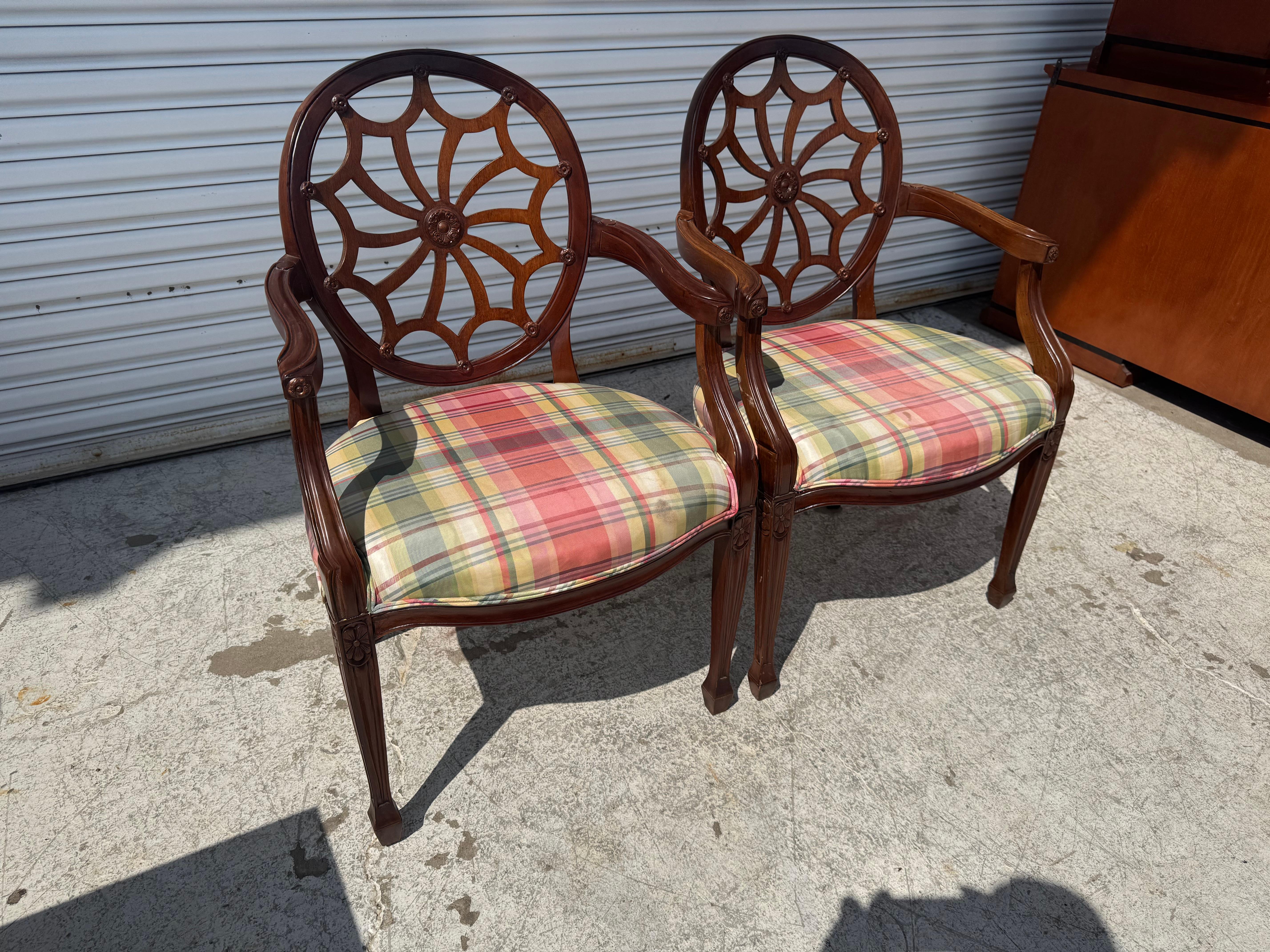 These chairs are made in the style of Edward Ferrell.
They're modeled in the Hepplewhite style.
They're made of mahogany and have cobweb backs.