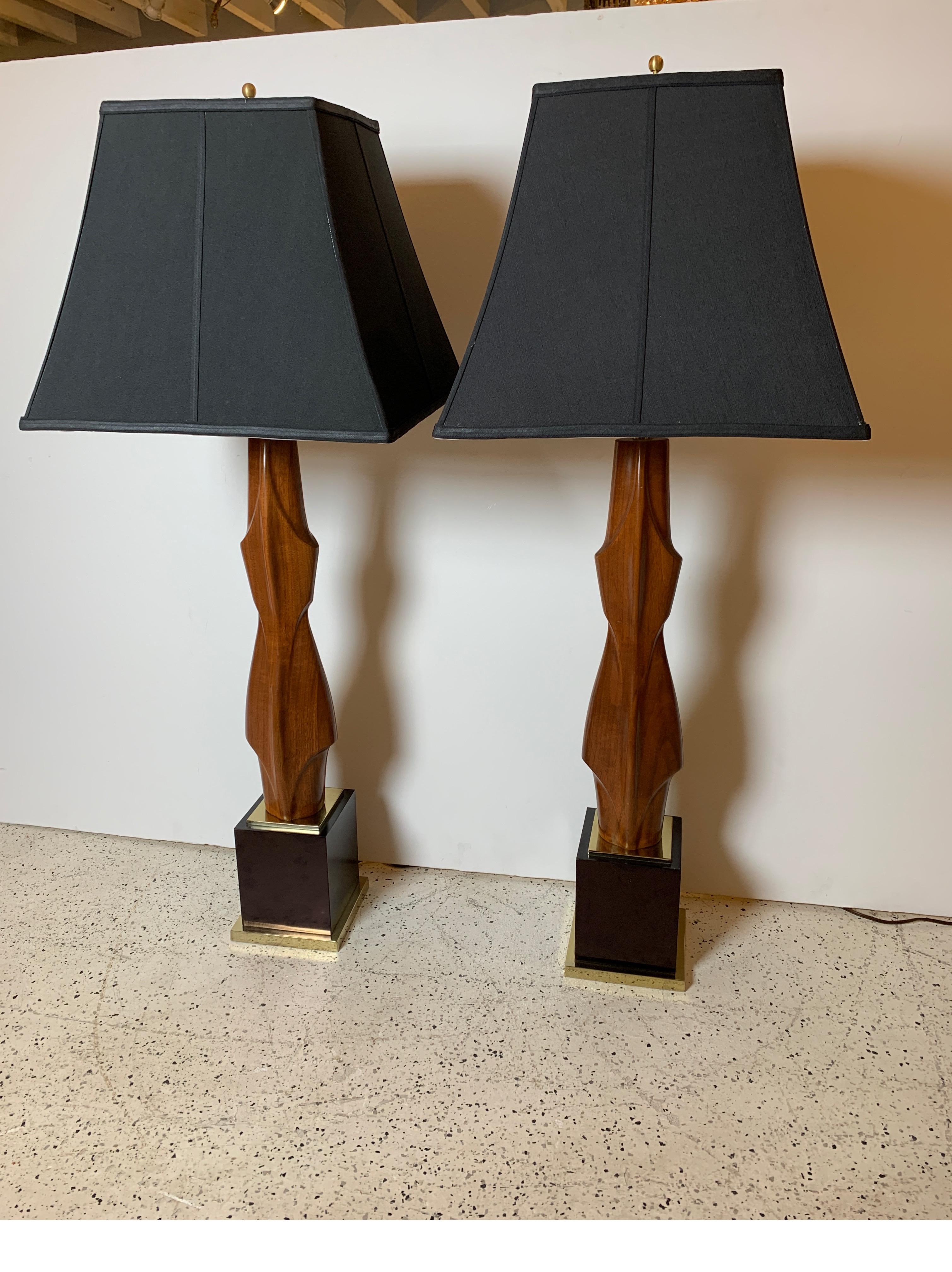 A pair of midcentury mahogany lamps by Laurel Lamp as featured in Don Draper's (Mad men) office. Arresting sculptural form that satisfies both art and lighting needs, late 1950s. The shades are for photographic purposes and not included with the