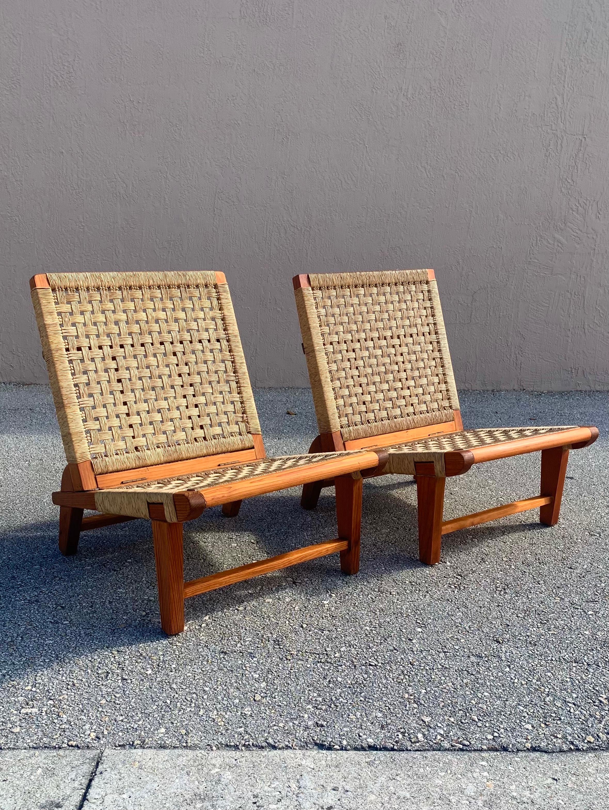 A pair of folding chairs by Michael van Beuren for his company Domus of Mexico. Made from mahogany and woven rattan cord. Chairs are made to have their back support fold down. 

Circa 1950. Lightly restored in an effort to extend its life and make