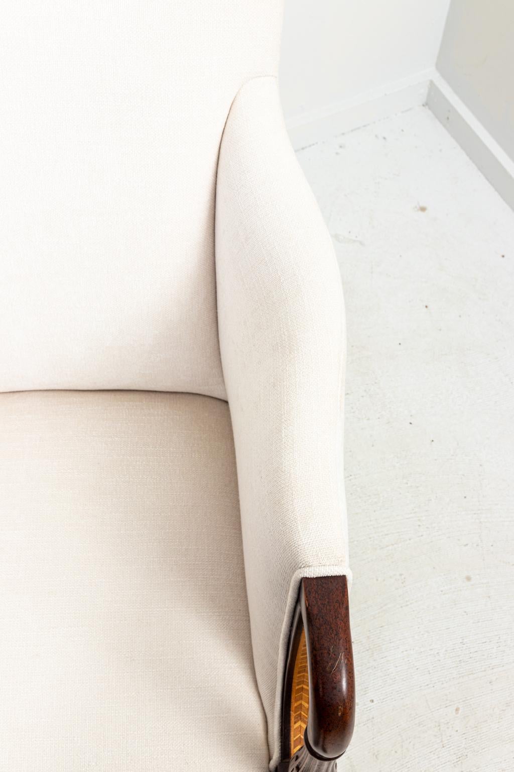 Pair of armchairs freshly upholstered with turned legs, ring turned arm rests, and arm supports, circa 1960s. Made in the United States. Please note of wear consistent with age.