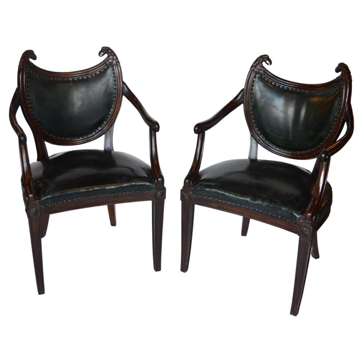 French Bistro arm chair set with green leather upholstery. Beautifully carved mahogany wood with eagle finials and brass nail heads on the seat and back.