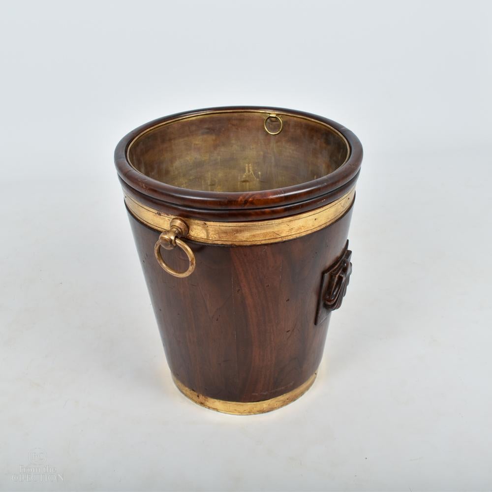 Pair of Mahogany George II rare peat buckets circa 1780 with original metal lining and brass carrying handles, brass band and shell motif to the front.