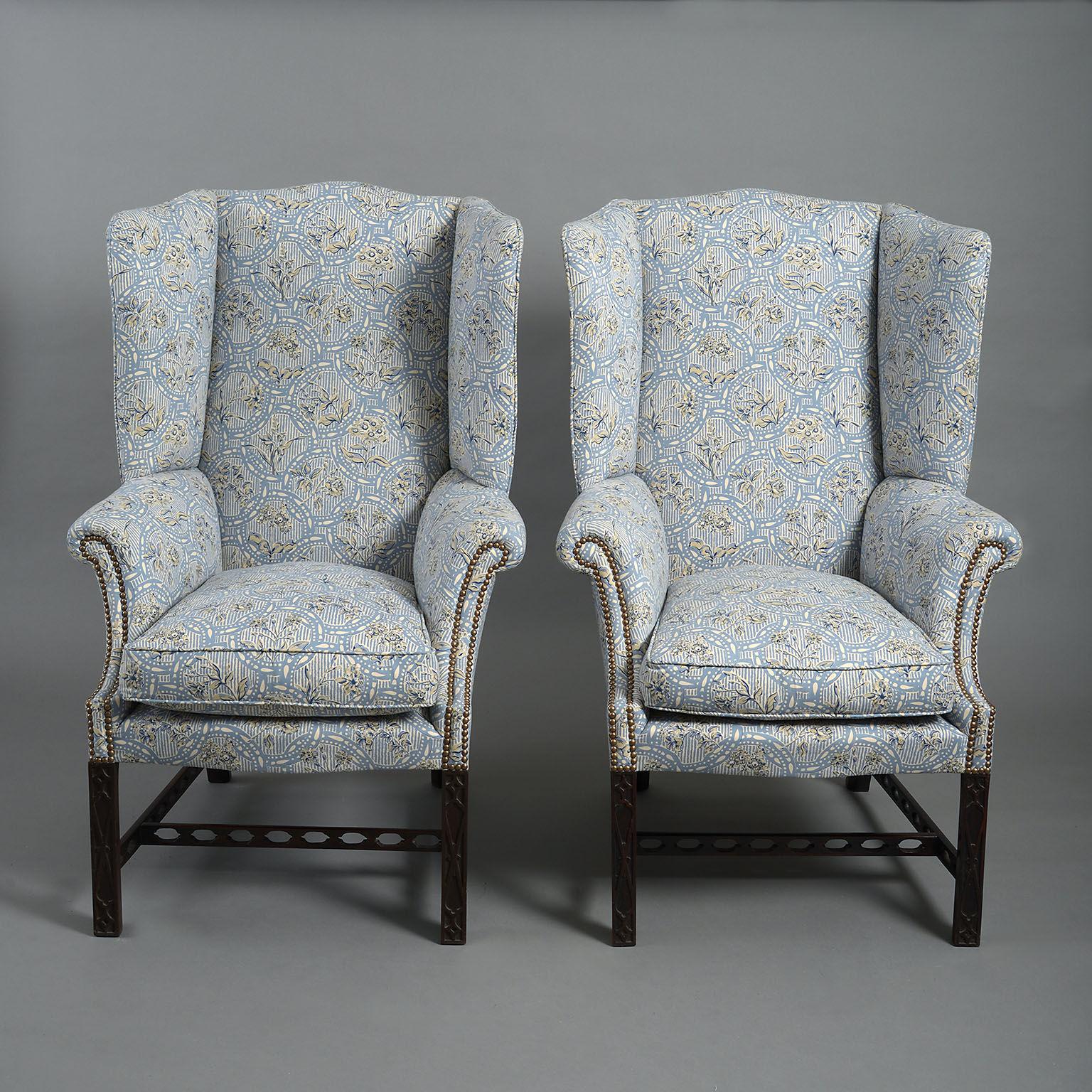 The serpentine cresting leading down to well-shaped wings above scroll arms with close-nailed detail. The seats feather-filled pads standing on blind-fret decorated legs joined by pierced stretchers. Fully re-upholstered and with new feather