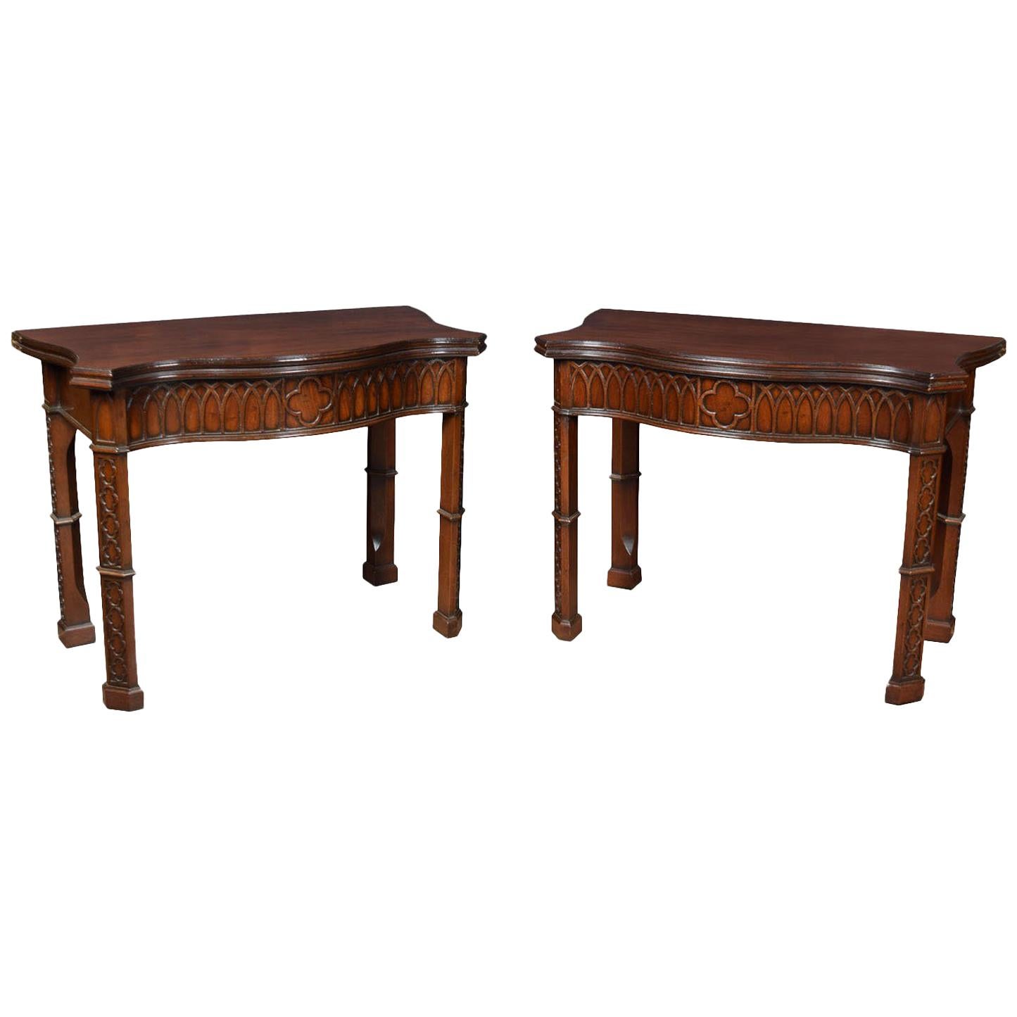 Pair of Gothic Revival card tables of serpentine outline fitted with swivel tops opening to reveal a baize lined interior above geometric carved freeze all raised up on four chamfered blind fret carved legs.

Dimensions:

Height 30.5