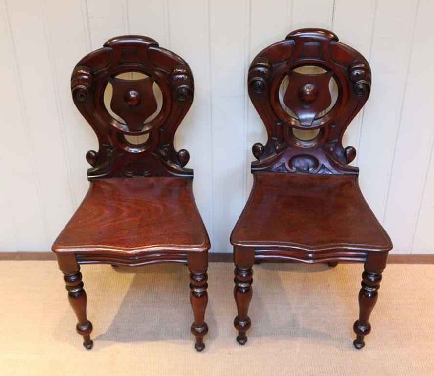 Polished Pair of Mahogany Hall Chairs For Sale