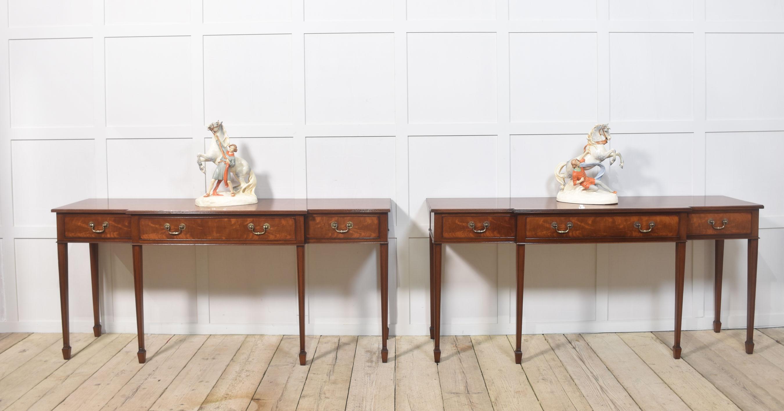Pair of mahogany serving tables, the large rectangular well-figured breakfront top above three freeze drawers fitted with brass handles. All raised on six tapering legs terminating in spade feet.
Dimensions
Height 33.5 Inches
Width 72.5 Inches
Depth