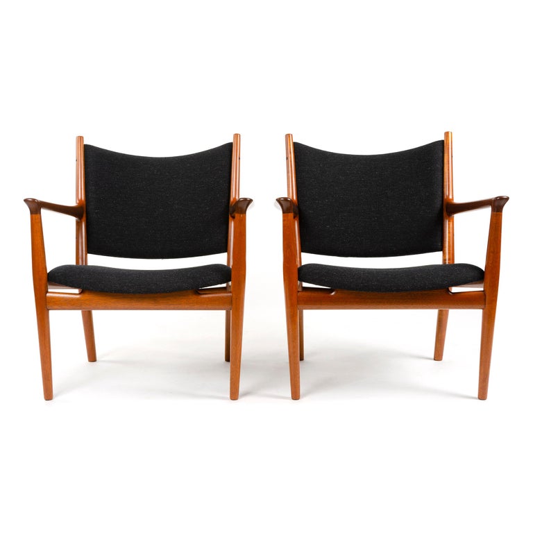 An uncommon pair of mahogany lounge chairs newly upholstered in dark grey wool savak.