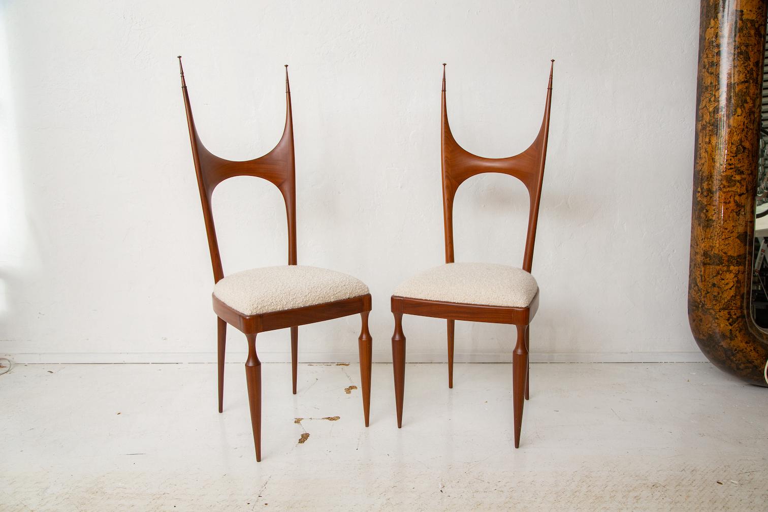 Rare pair of mid-century Italian tall back chairs by Pozzi and Verga, exquisitely crafted in mahogany with new boucle upholstery.