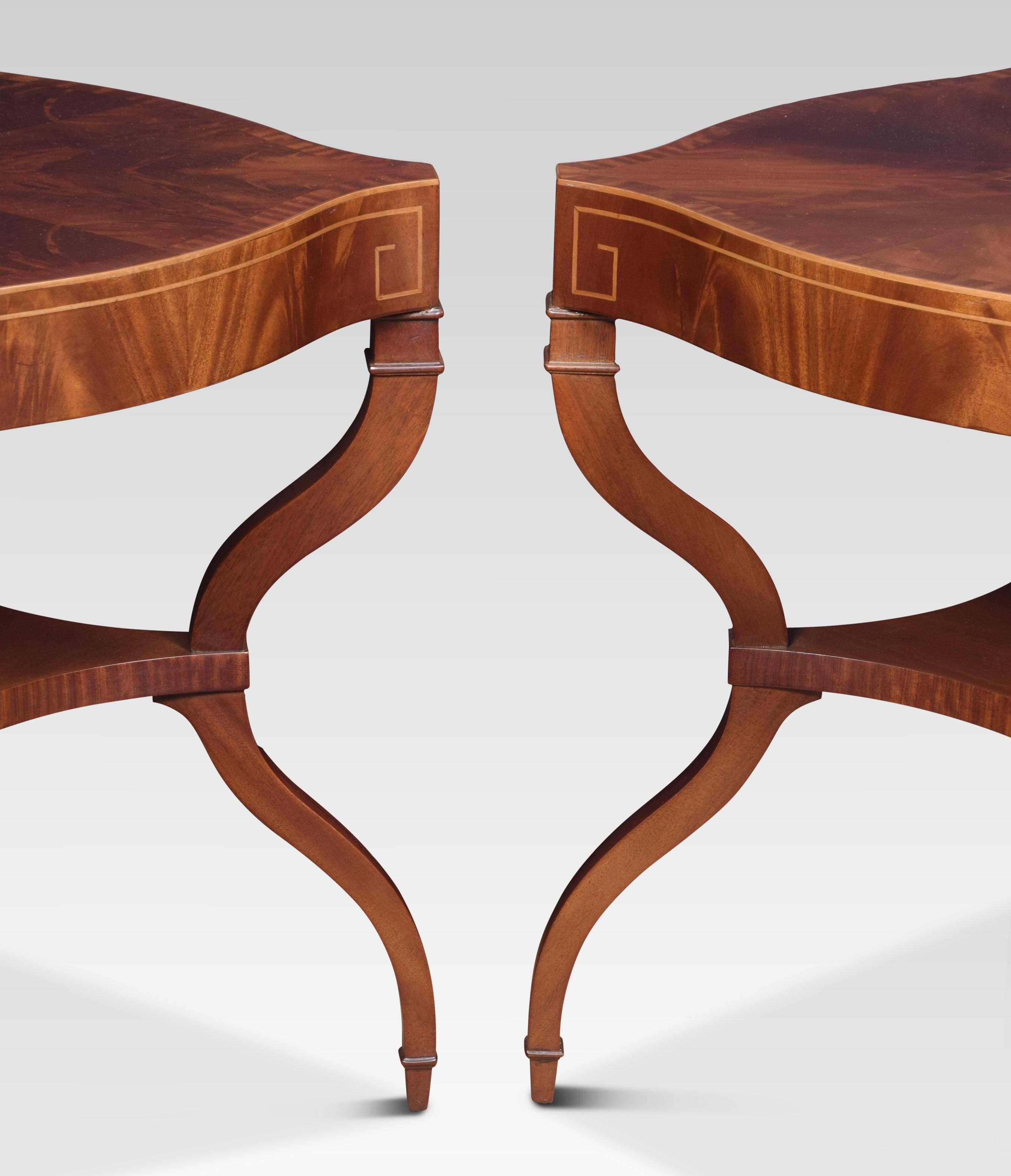 Pair of mahogany lamp tables, the crossbanded flame mahogany quatrefoil tops raised on four inlaid curved legs united by under tier.
Dimensions
Height 27.5 inches
Width 25 inches
Depth 25 inches.
