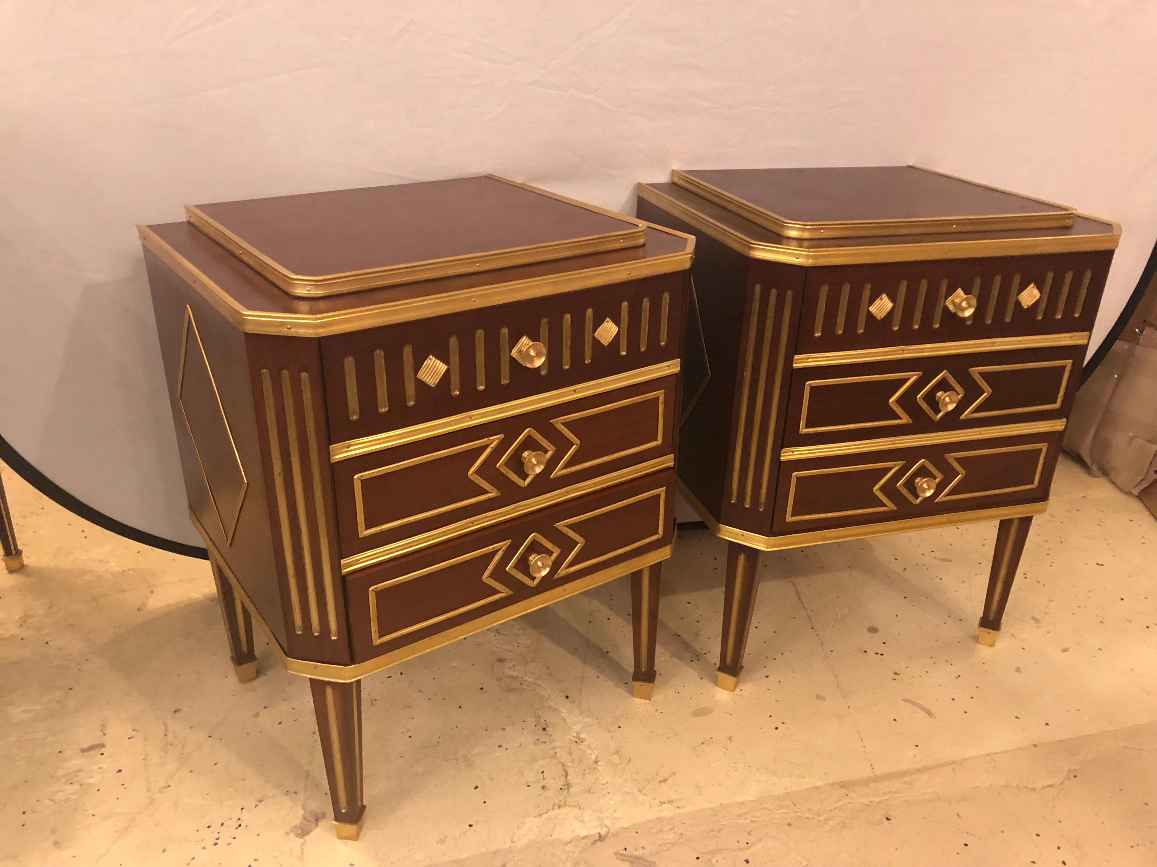 Pair of Russian neoclassical style commodes or nightstands. A fine pair of Russian fashioned three-drawer bronze framed and heavily bronze inlaid end tables which are large enough to be used as small commodes or large nightstands. Each supported by