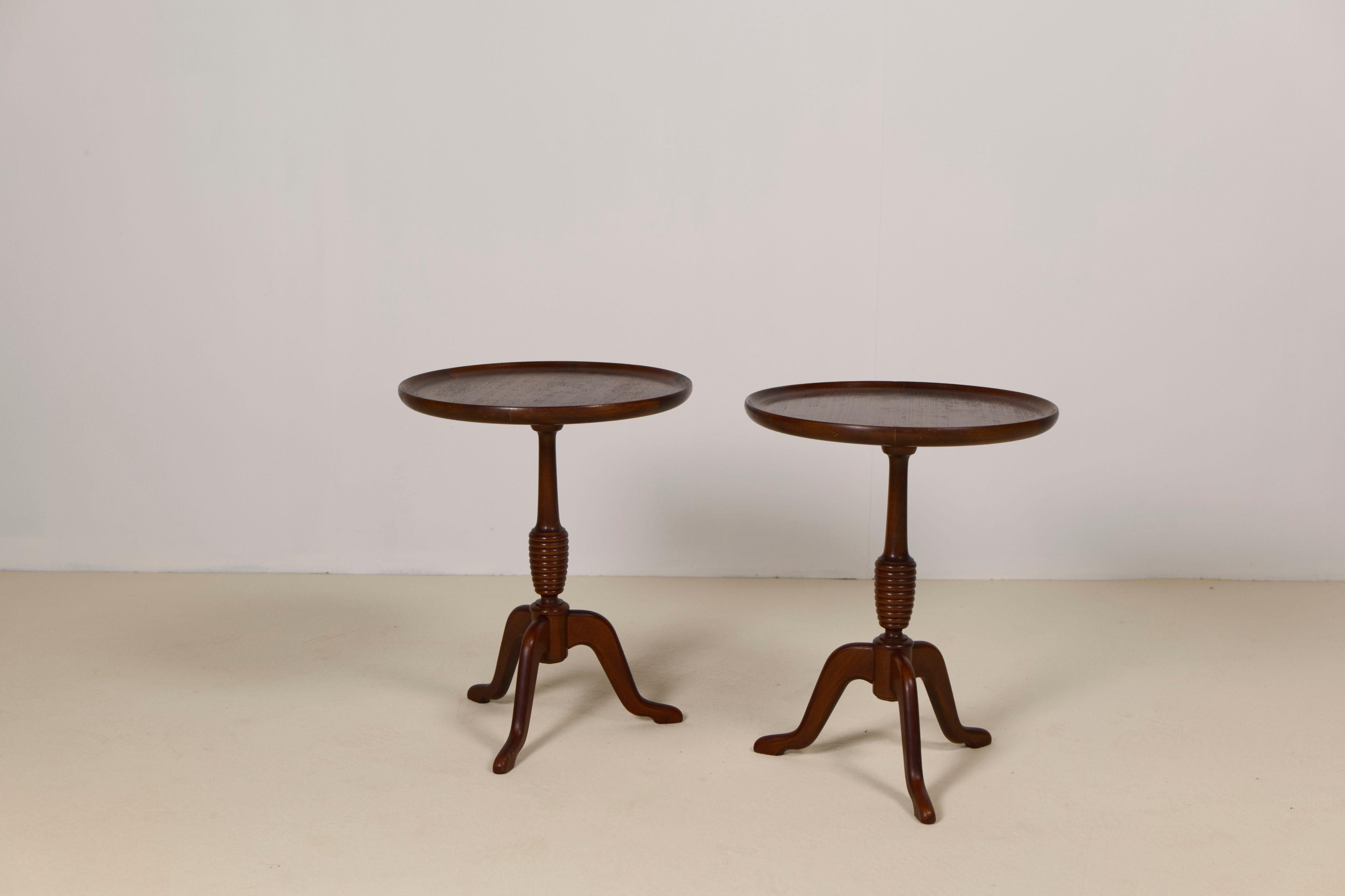 A elegant pair of mahogany side tables 'model 210' made by Anton Kildeberg. Different version of this table were made during the 50s, 60s and 70s. Made from a solid beech turned base with an unscrew-able top with mahogany veneer. A simple and