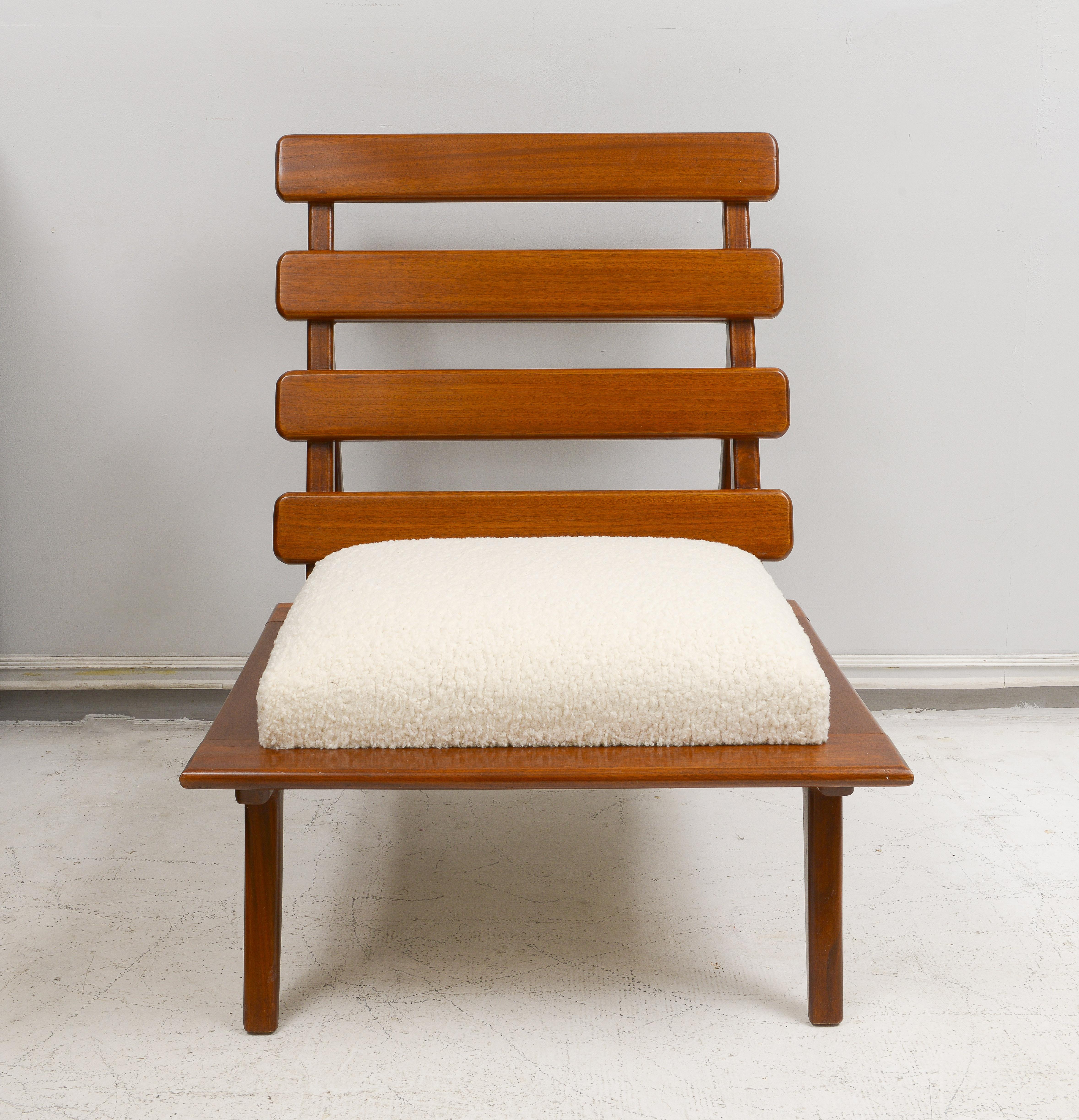 Pair of sculptural mahogany lounge chairs upholstered in boucle fabric. Set of 2.