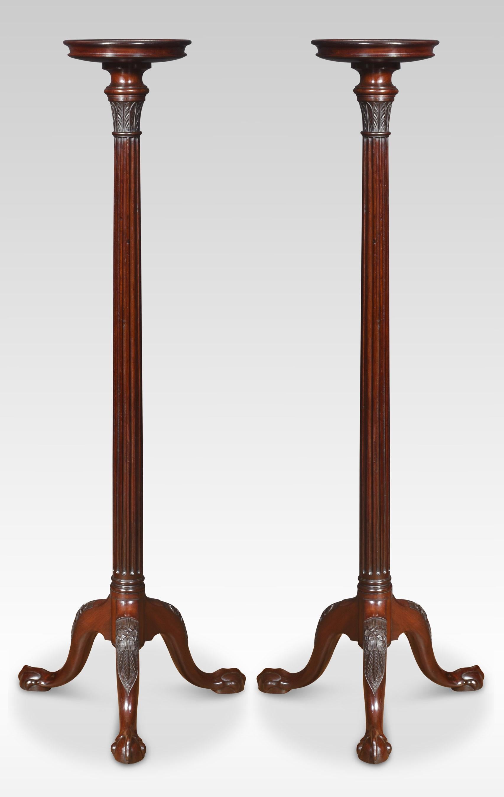 A pair of mahogany plant stands the circular tops above carved acanthus detail and reeded tapered column below, raised up on tripod base with cabriole legs and terminating in claw and ball feet.
Dimensions
Height 54.5 Inches
Width 21 Inches
Depth 21