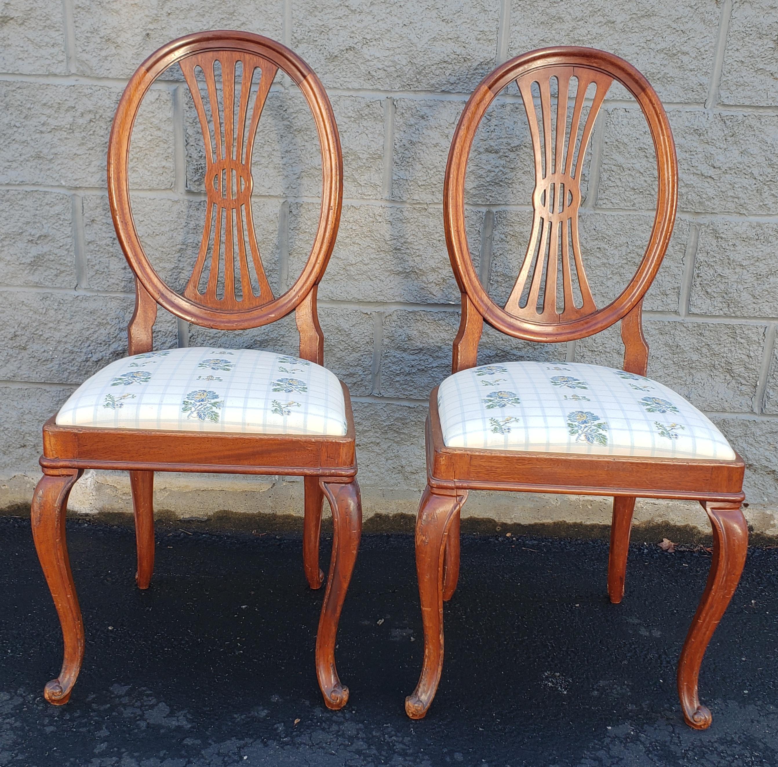 Pair of mahogany upholstered shieldback chairs.
