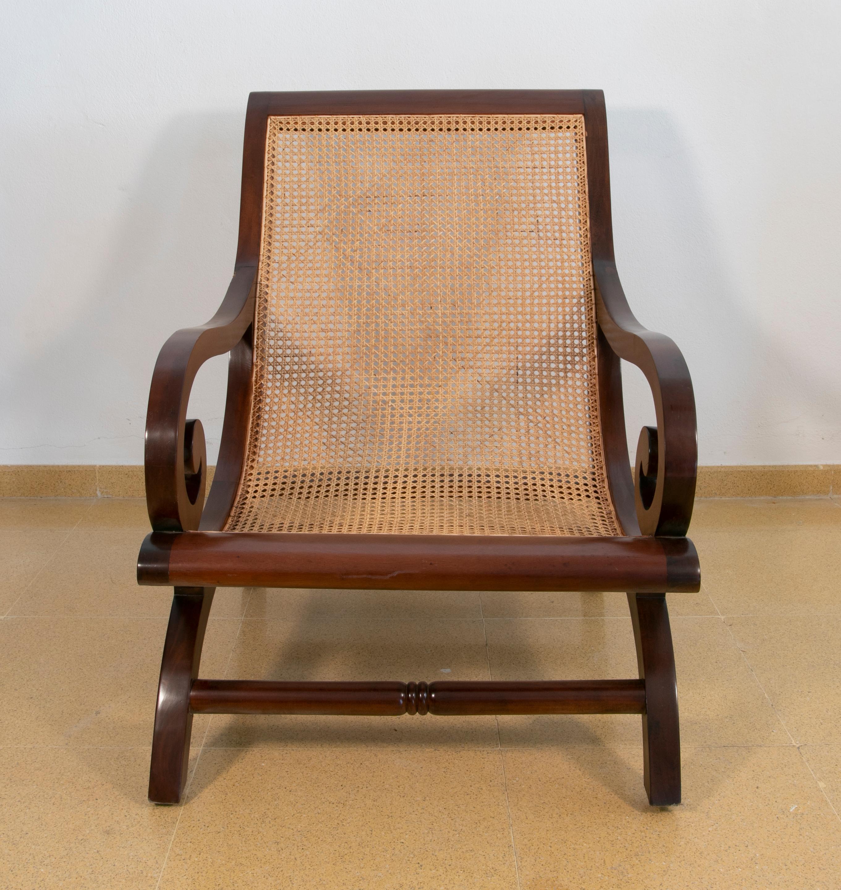 Pair of mahogany wooden armchairs with wicker grid seats.